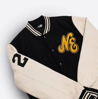 black & white varsity jacket with gold new era writing