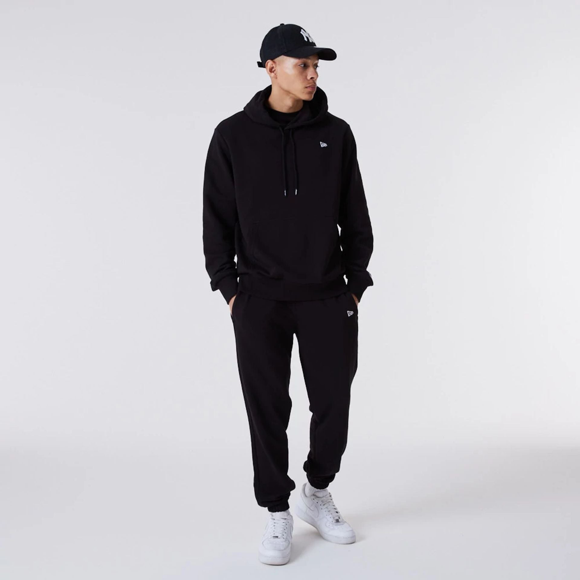 The Male model is wearing New Era Essential Flag Black Hoodie 7