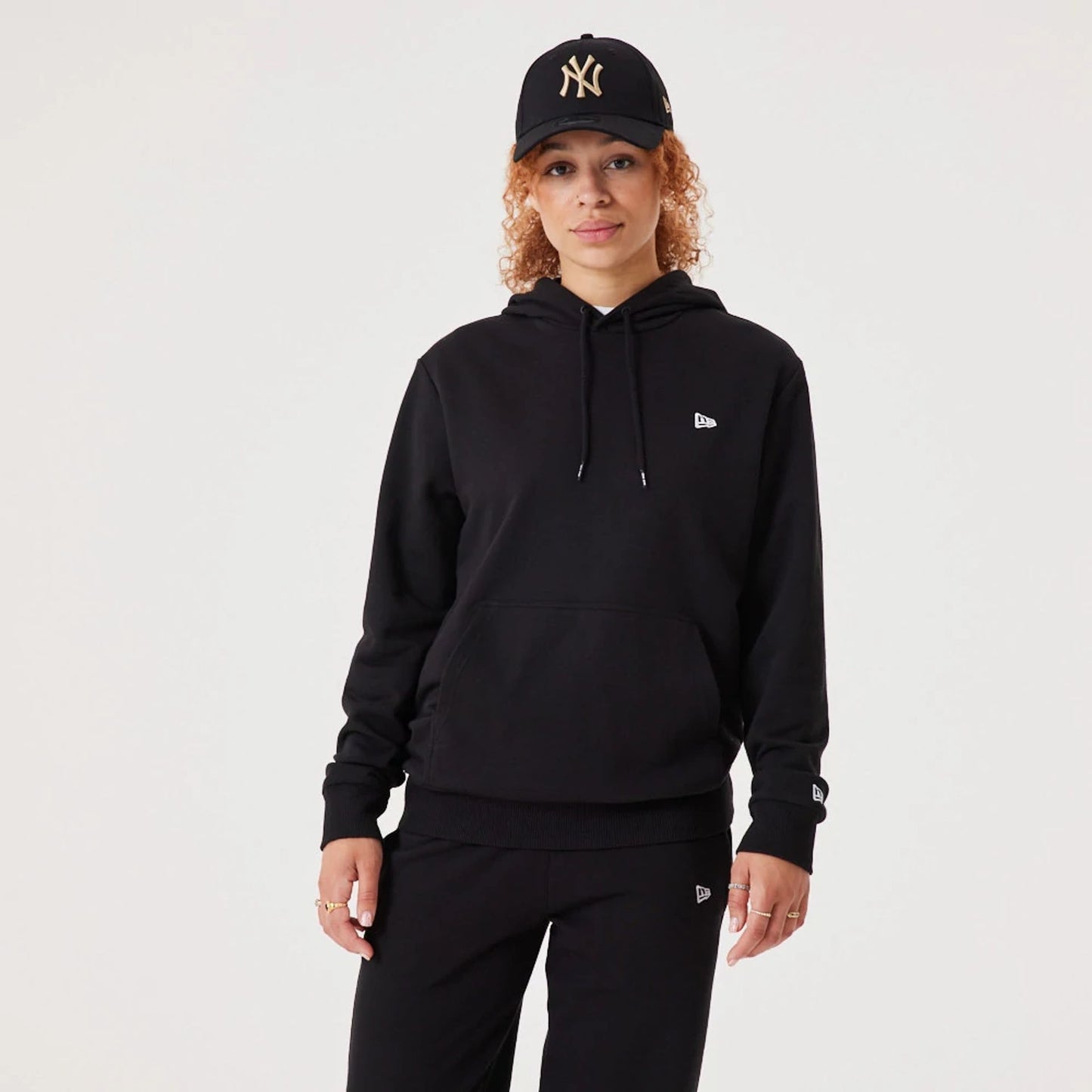 The Male model is wearing New Era Essential Flag Black Hoodie 2