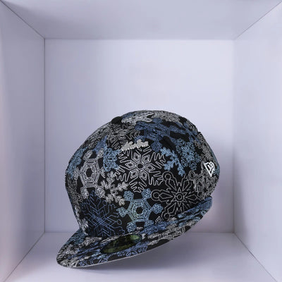 Black New Era 59Fifty cap with blue and white snow flake designs.