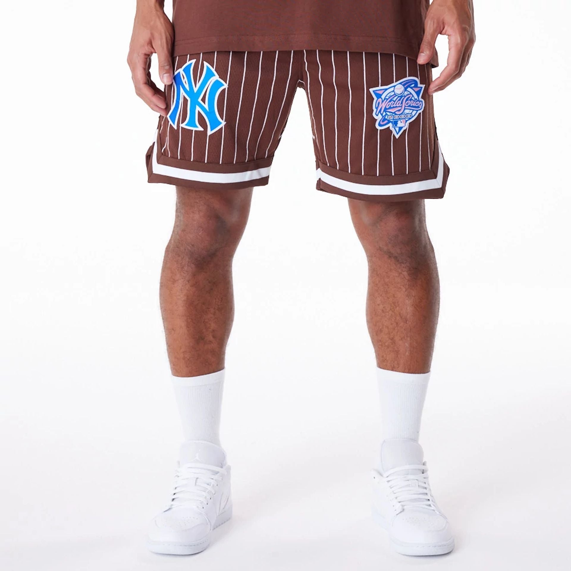 The Male model is wearing New York Yankees Pinstripe New Era Australia Brown Shorts 1