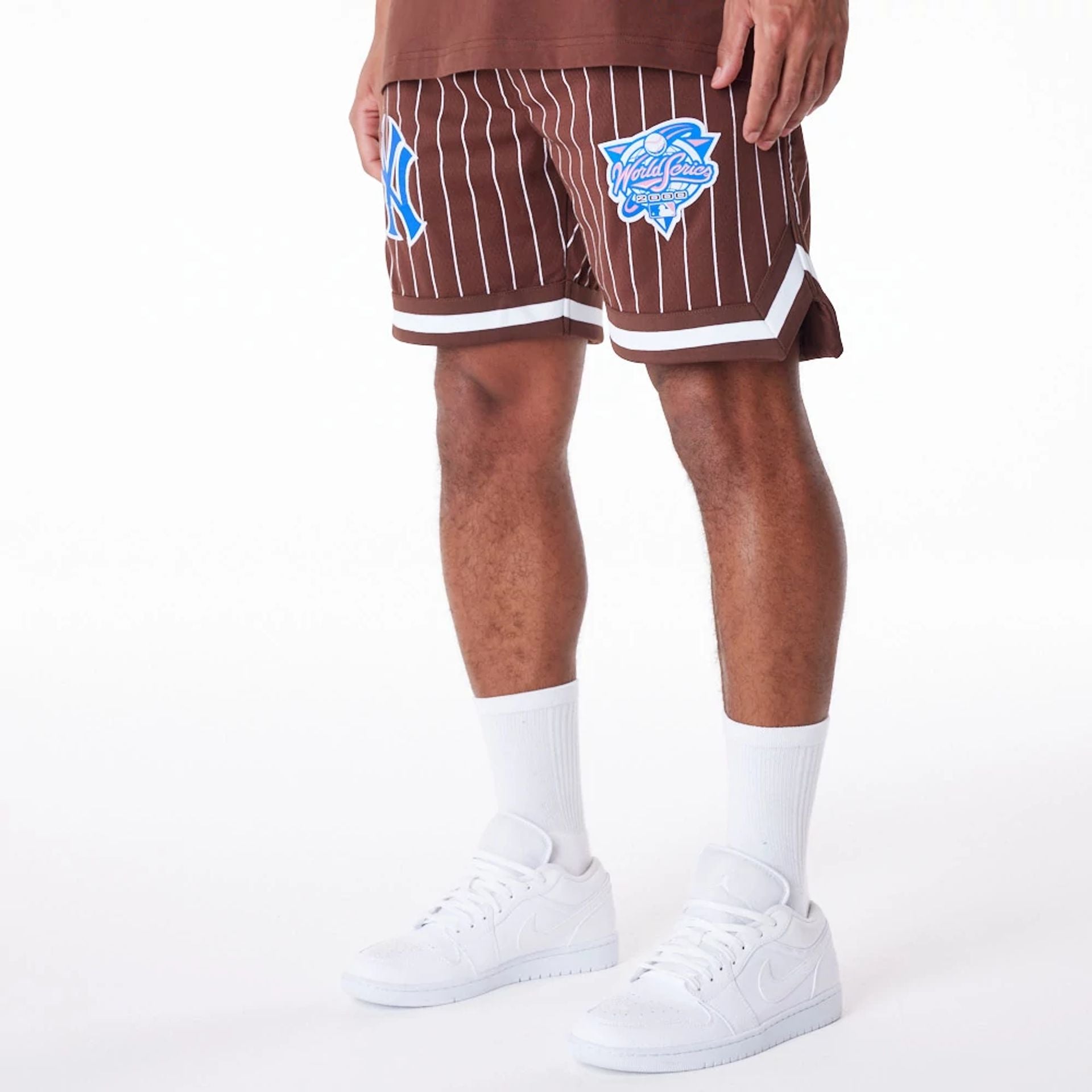 The Male model is wearing New York Yankees Pinstripe New Era Australia Brown Shorts 9