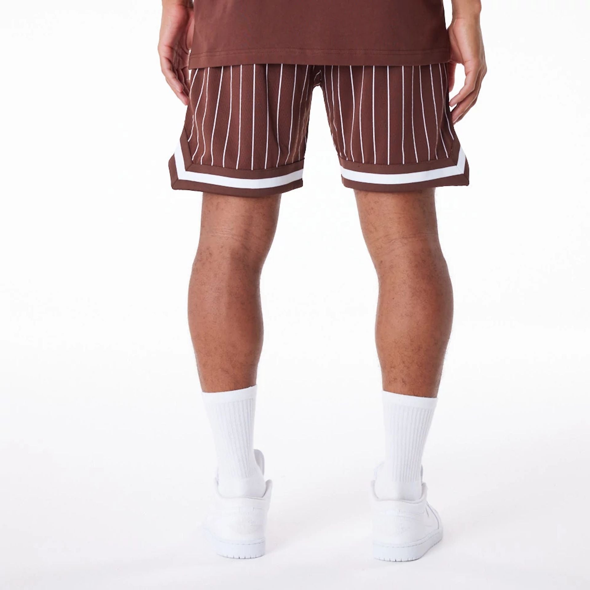 The Male model is wearing New York Yankees Pinstripe New Era Australia Brown Shorts 2