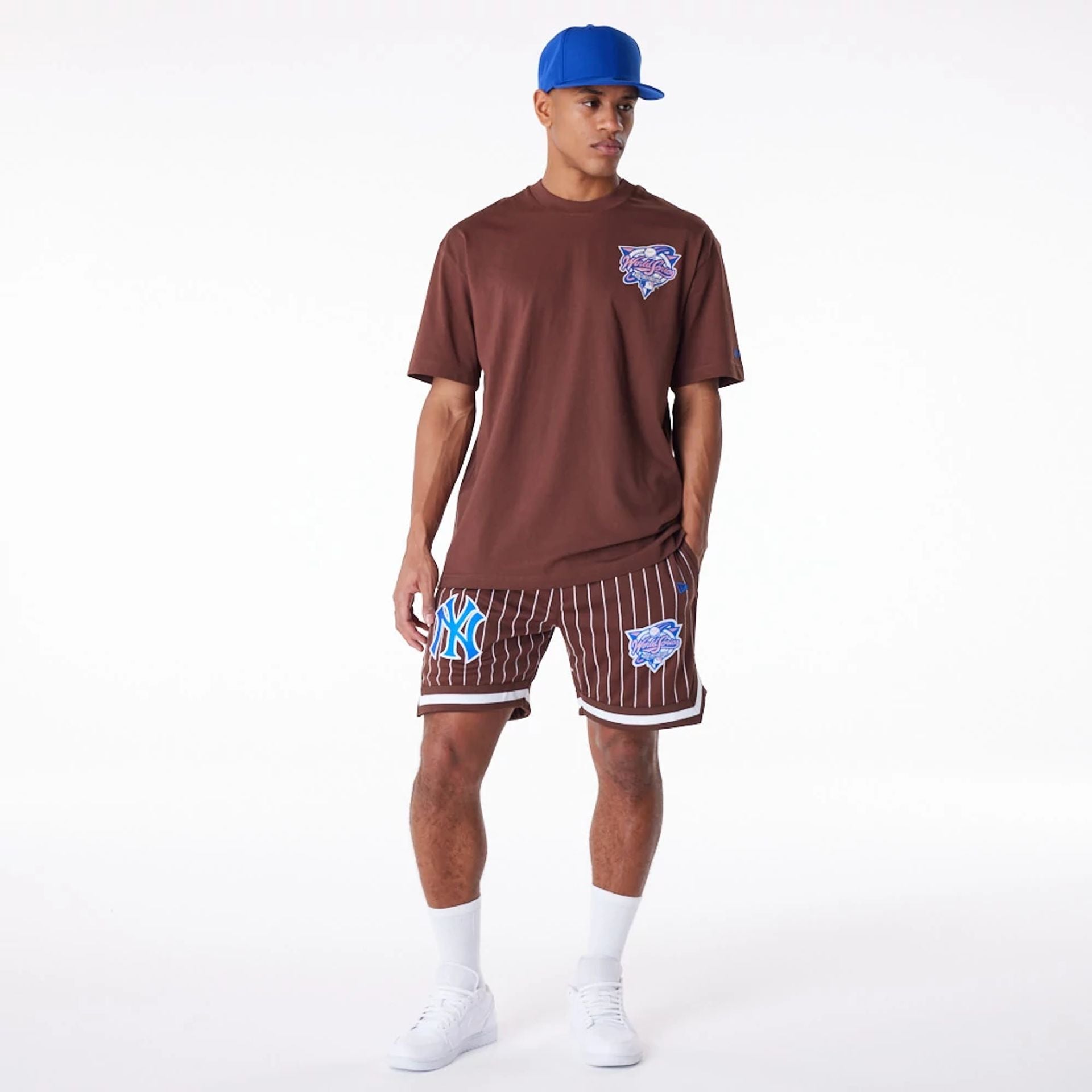 The Male model is wearing New York Yankees Pinstripe New Era Australia Brown Shorts 4