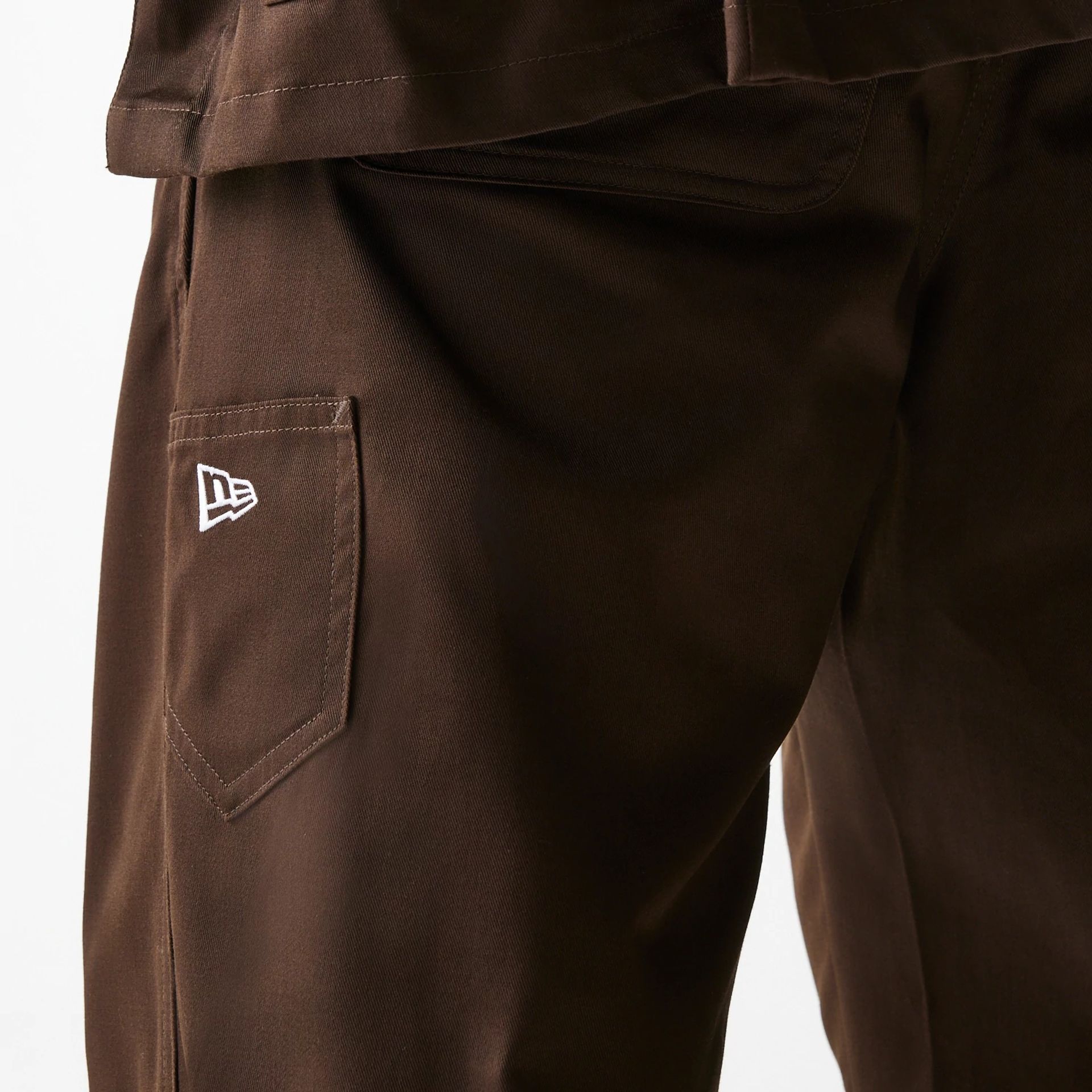 The Male model is wearing New Era Dark Brown Heavy Duty Trousers 4