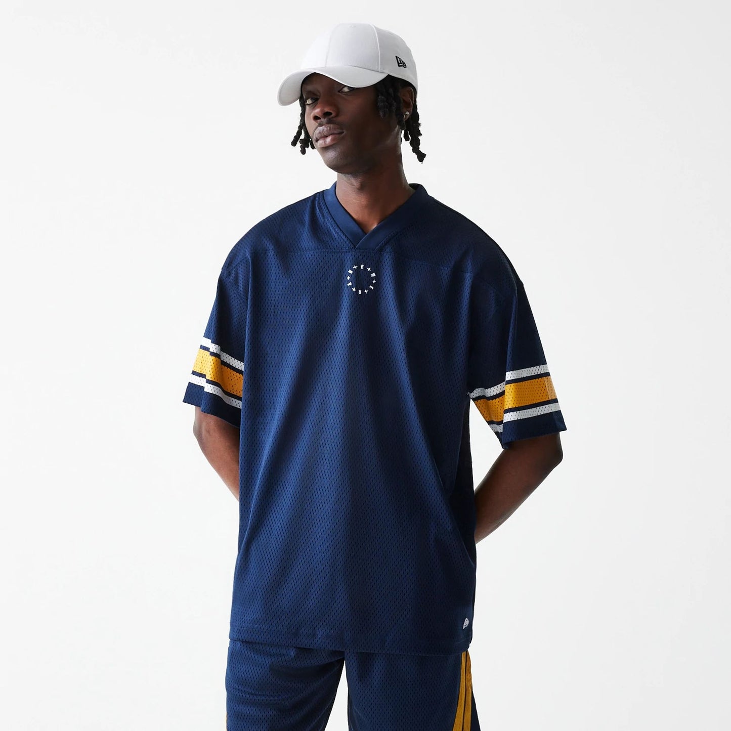 The Male model is wearing New Era Street Dangle Blue T-Shirt  1