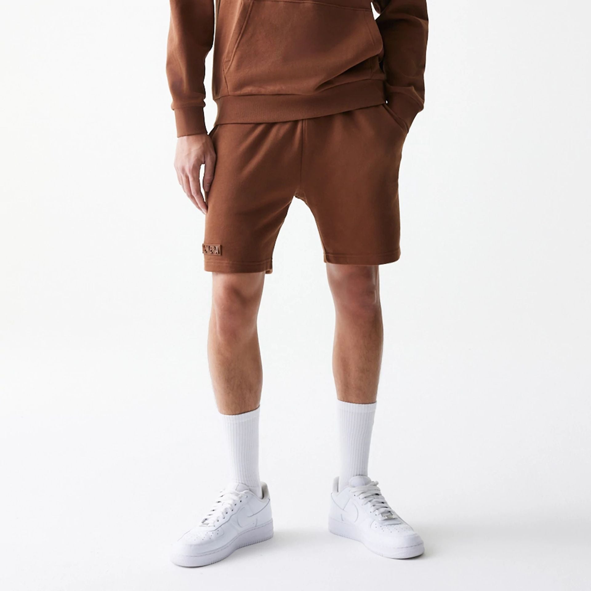 The Male model is wearing New Era Tonal Brown Shorts  1