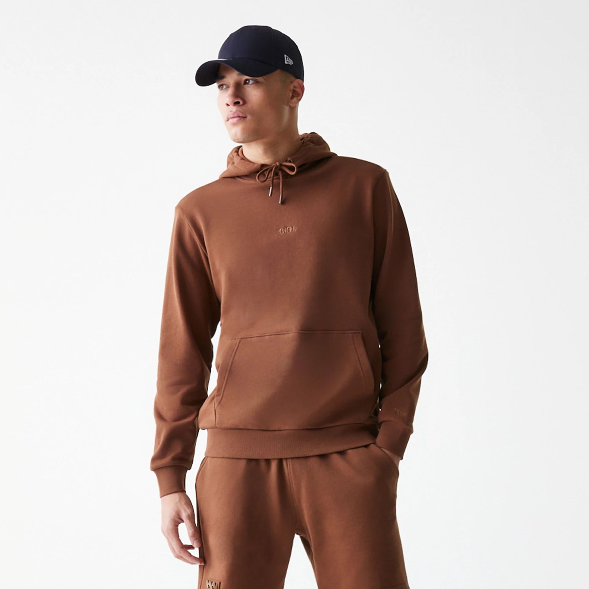 The Male model is wearing New Era Tonal Brown Pullover Hoodie  7