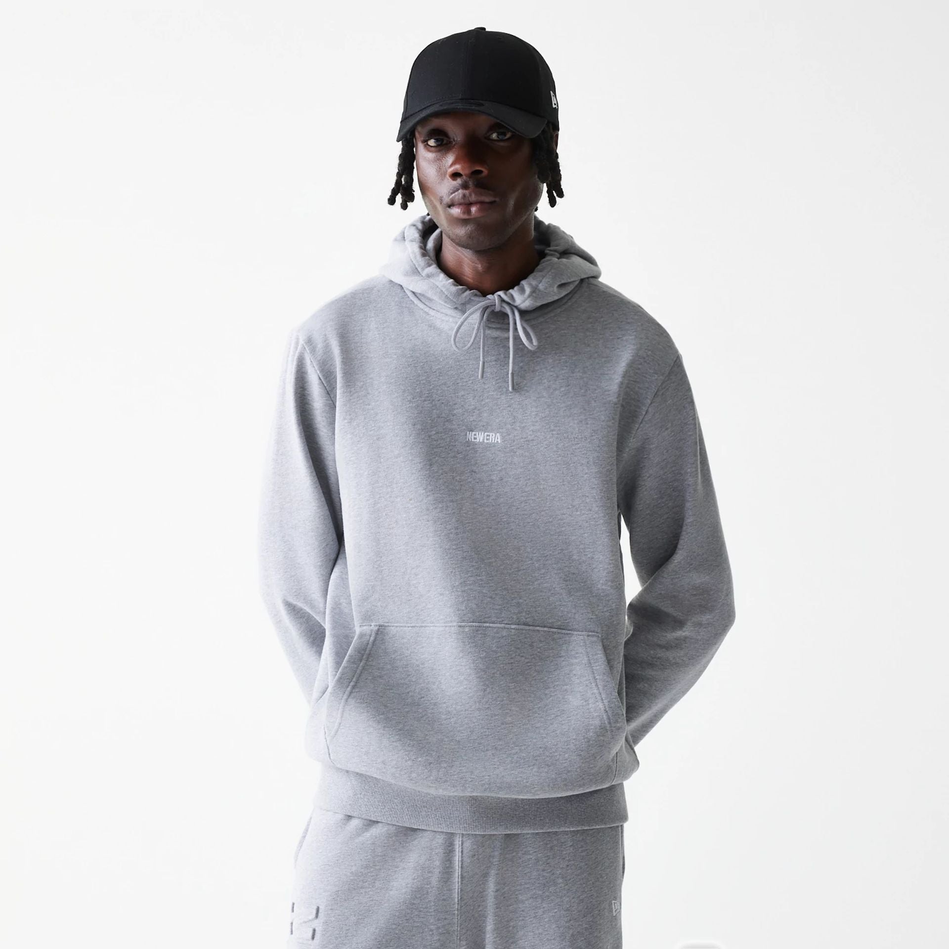 The Male model is wearing New Era Tonal Grey Pullover Hoodie  1