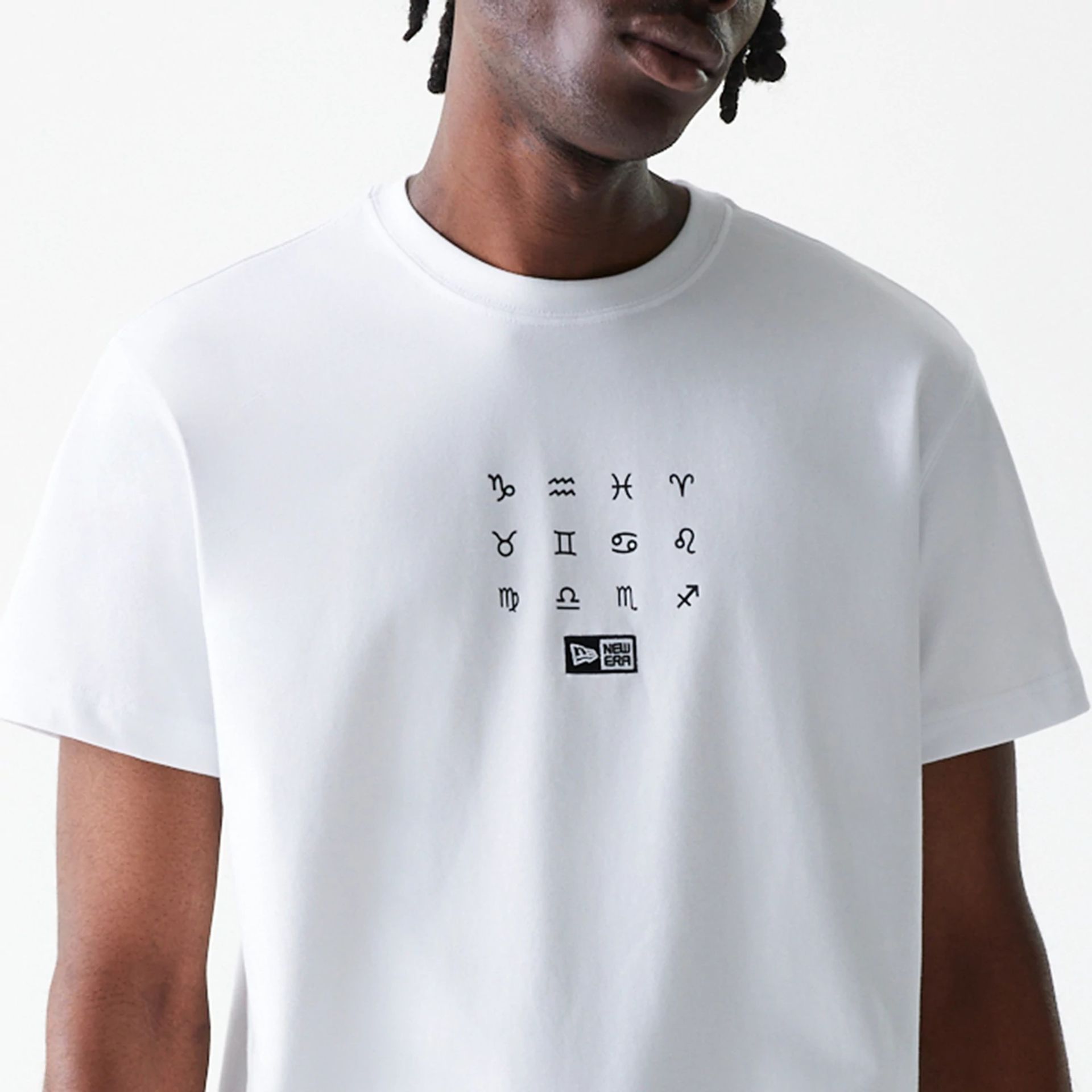 The Male model is wearing New Era Zodiac White T-Shirt 7