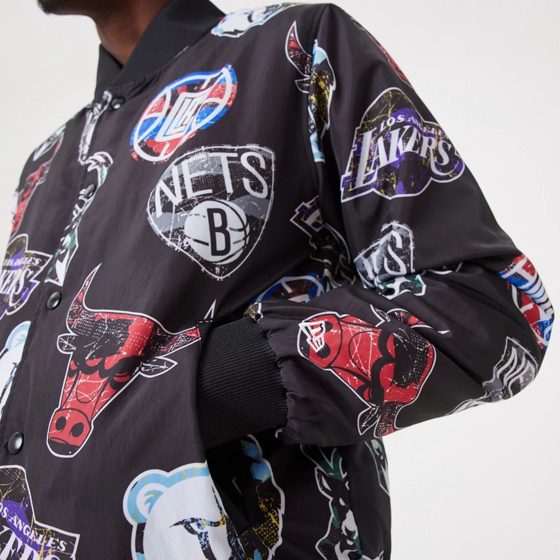 The Male model is wearing NBA All Over Print Team Logos Black Bomber Jacket 4