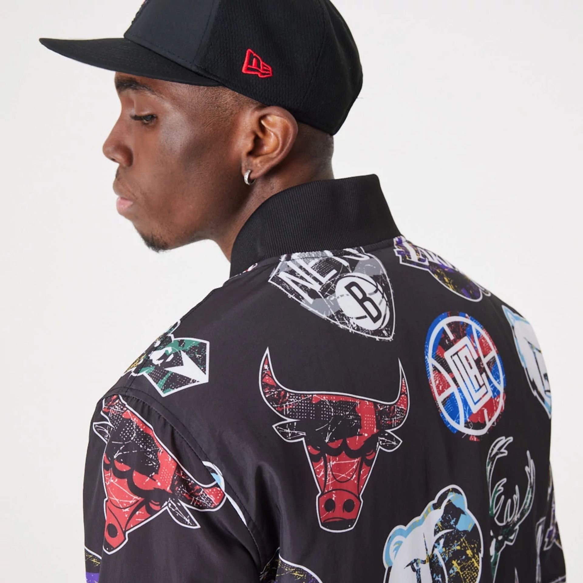 The Male model is wearing NBA All Over Print Team Logos Black Bomber Jacket 5