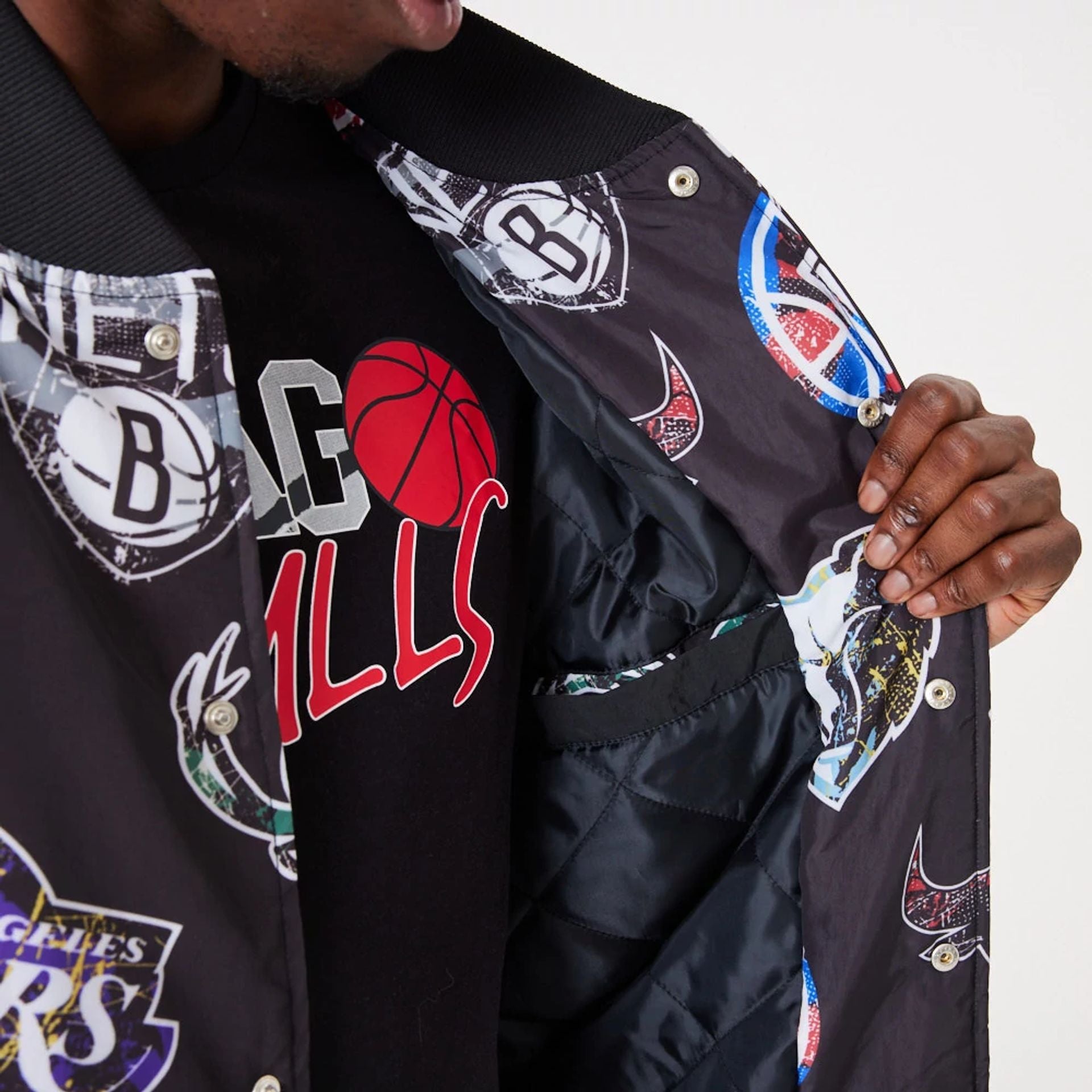 The Male model is wearing NBA All Over Print Team Logos Black Bomber Jacket 6