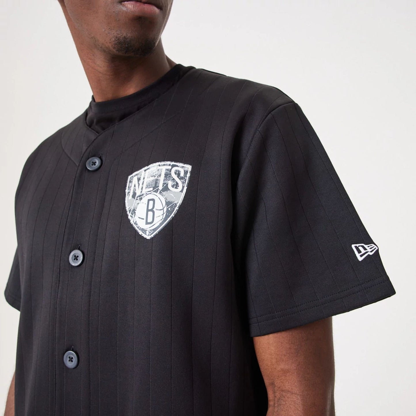 The Male model is wearing Brooklyn Nets NBA Infill Team Logo Black Jersey 4