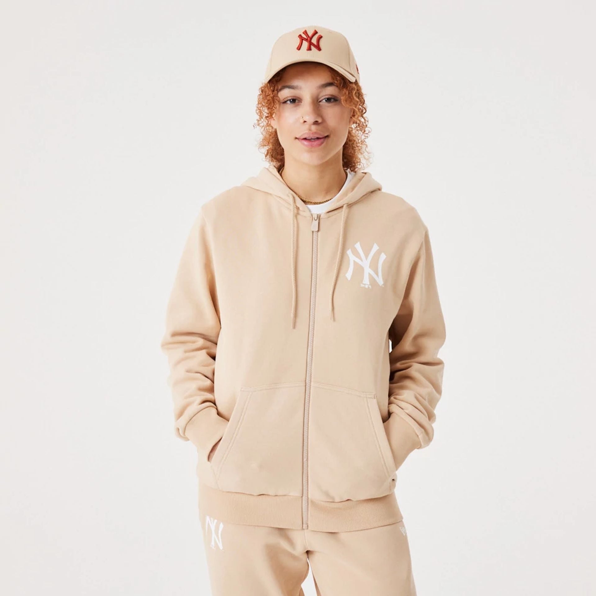 The Male model is wearing New York Yankees MLB League Essential Light Beige Full-Zip Hoodie 9