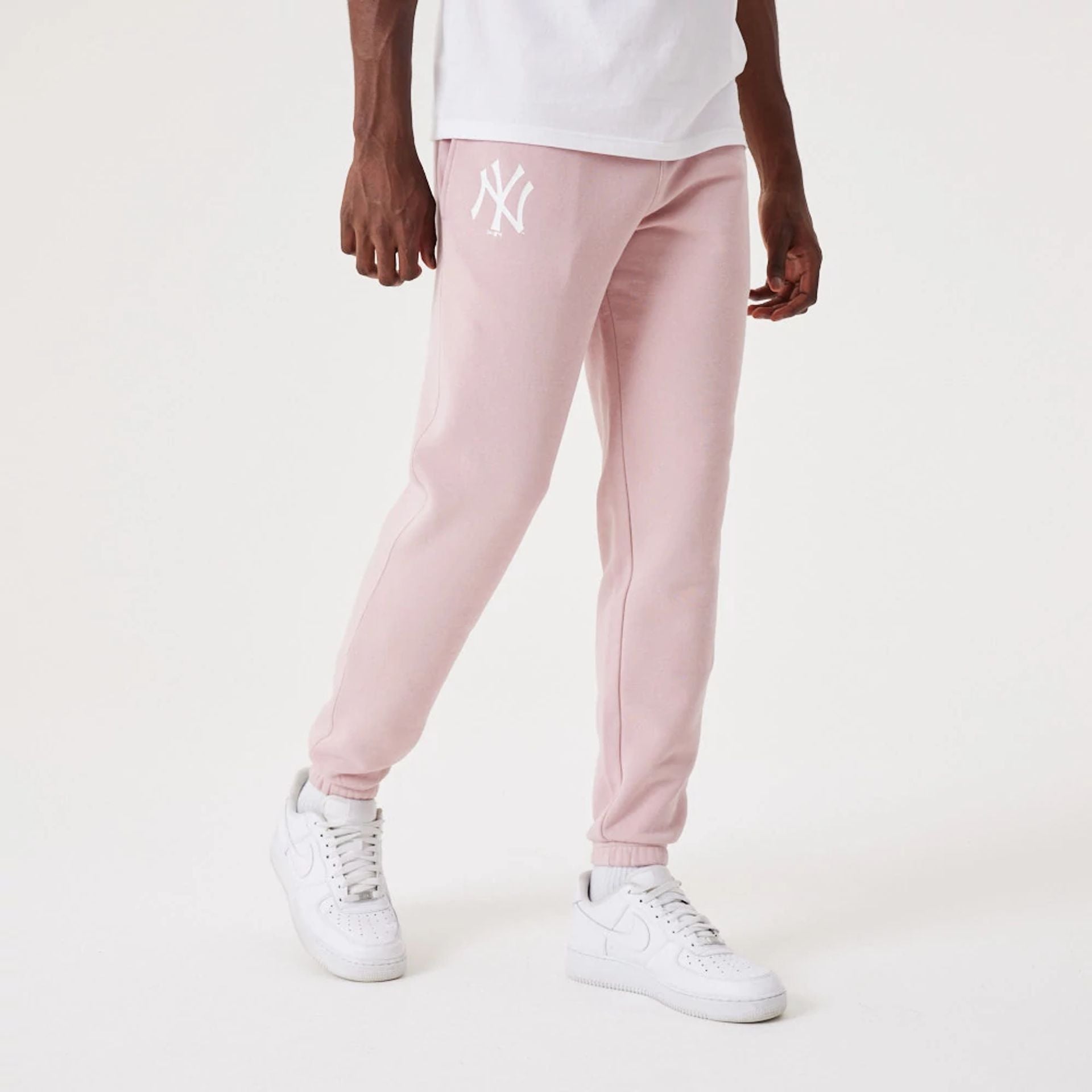 The Male model is wearing New York Yankees MLB League Essential Pastel Pink Joggers 1