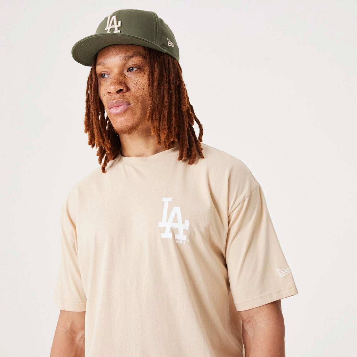 The Male model is wearing LA Dodgers MLB League Essential Light Beige Oversized T-Shirt 6