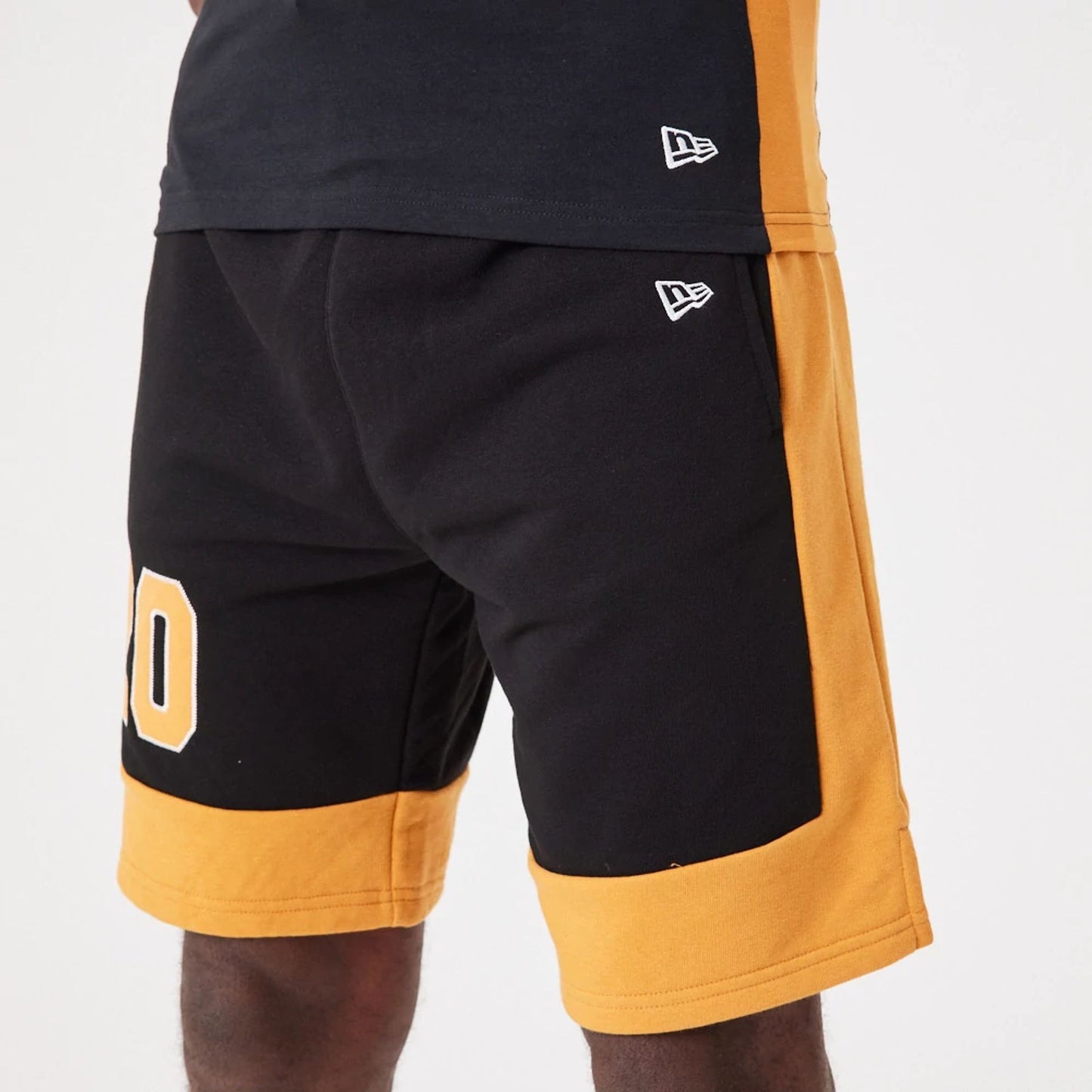 The Male model is wearing New Era Contemporary Black Oversized Shorts 4