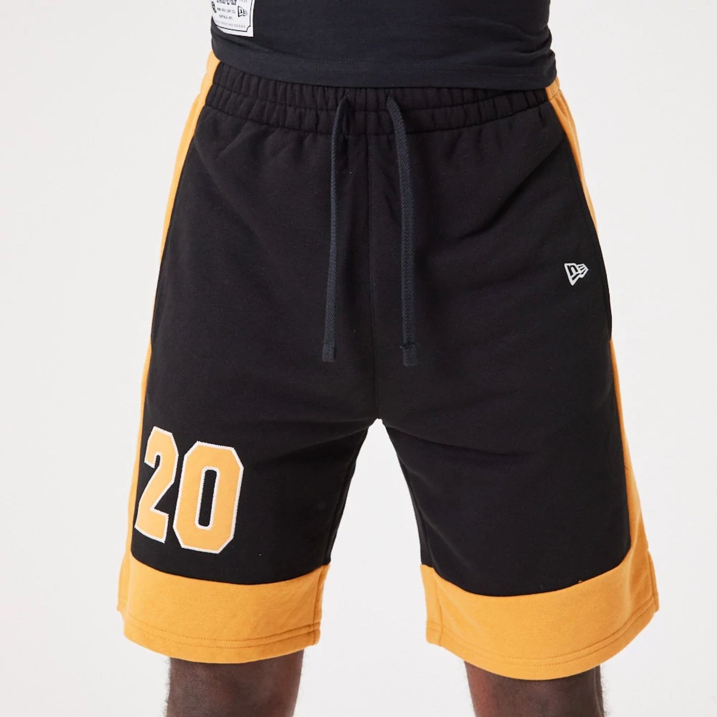 The Male model is wearing New Era Contemporary Black Oversized Shorts 6