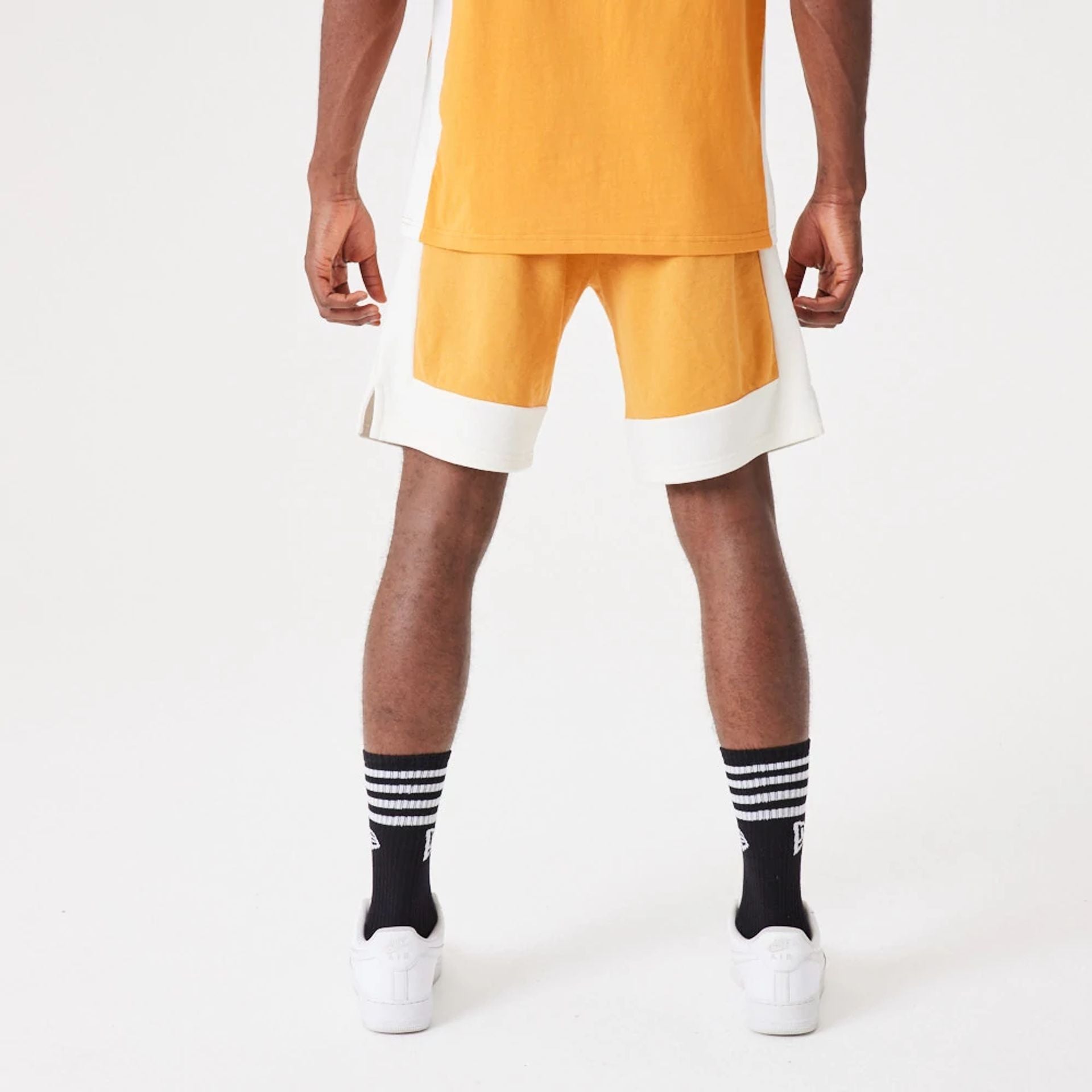 The Male model is wearing New Era Contemporary Medium Orange Oversized Shorts 2