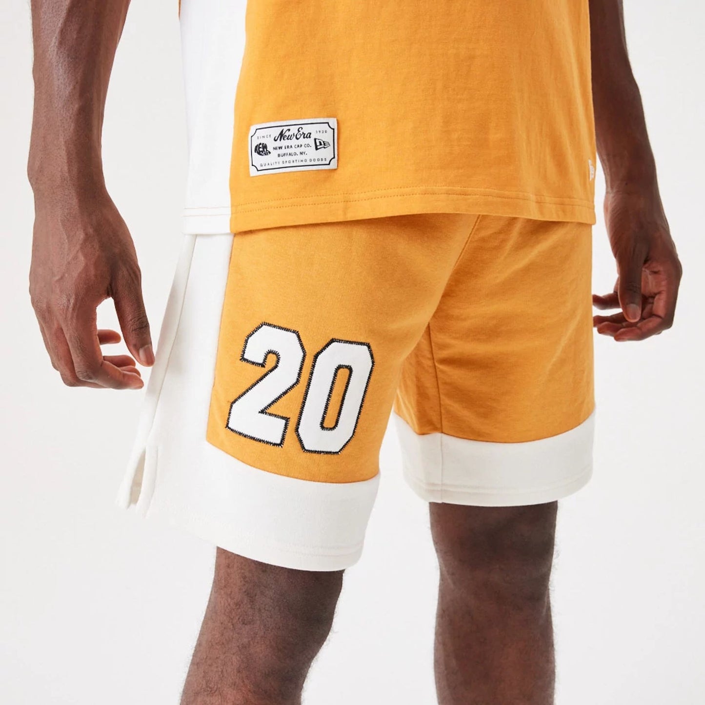 The Male model is wearing New Era Contemporary Medium Orange Oversized Shorts 3