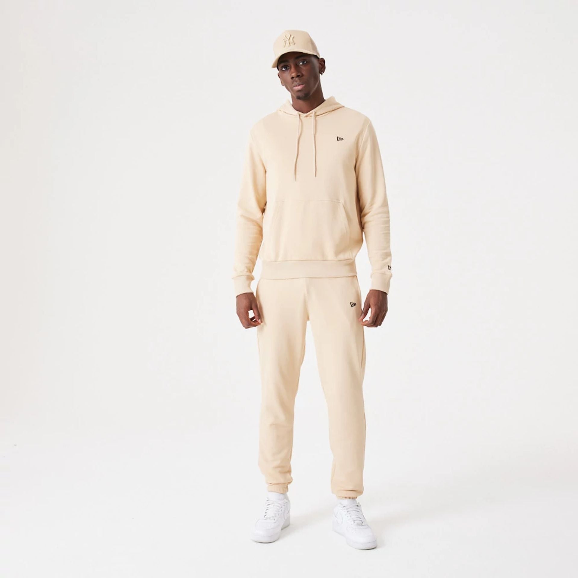 The Male model is wearing New Era Essential Light Beige Pullover Hoodie 9