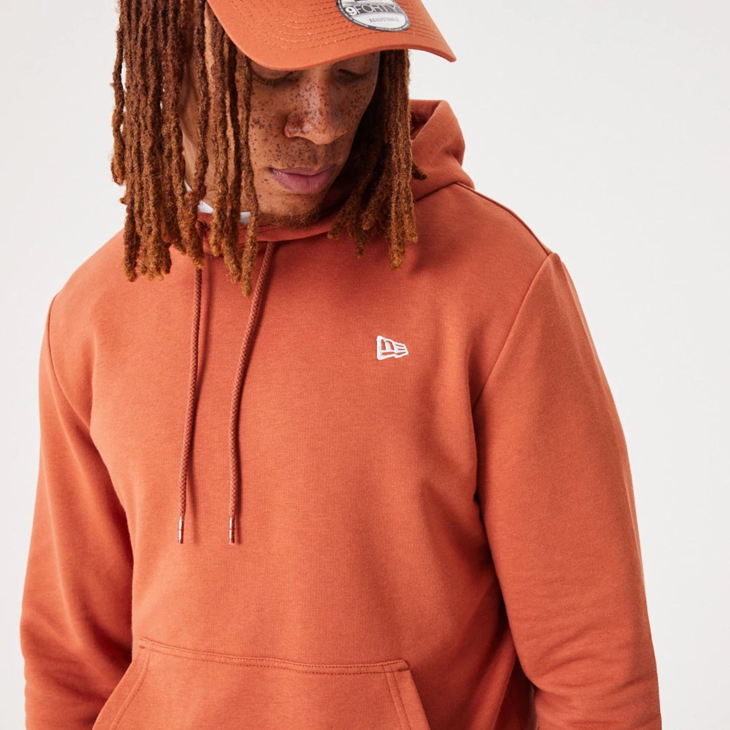 The Male model is wearing New Era Essential Medium Brown Pullover Hoodie 7