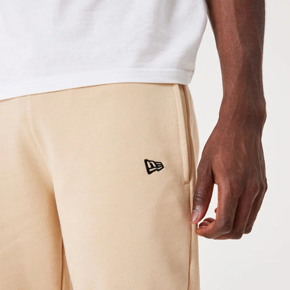 The Male model is wearing New Era Essential Light Beige Joggers 4