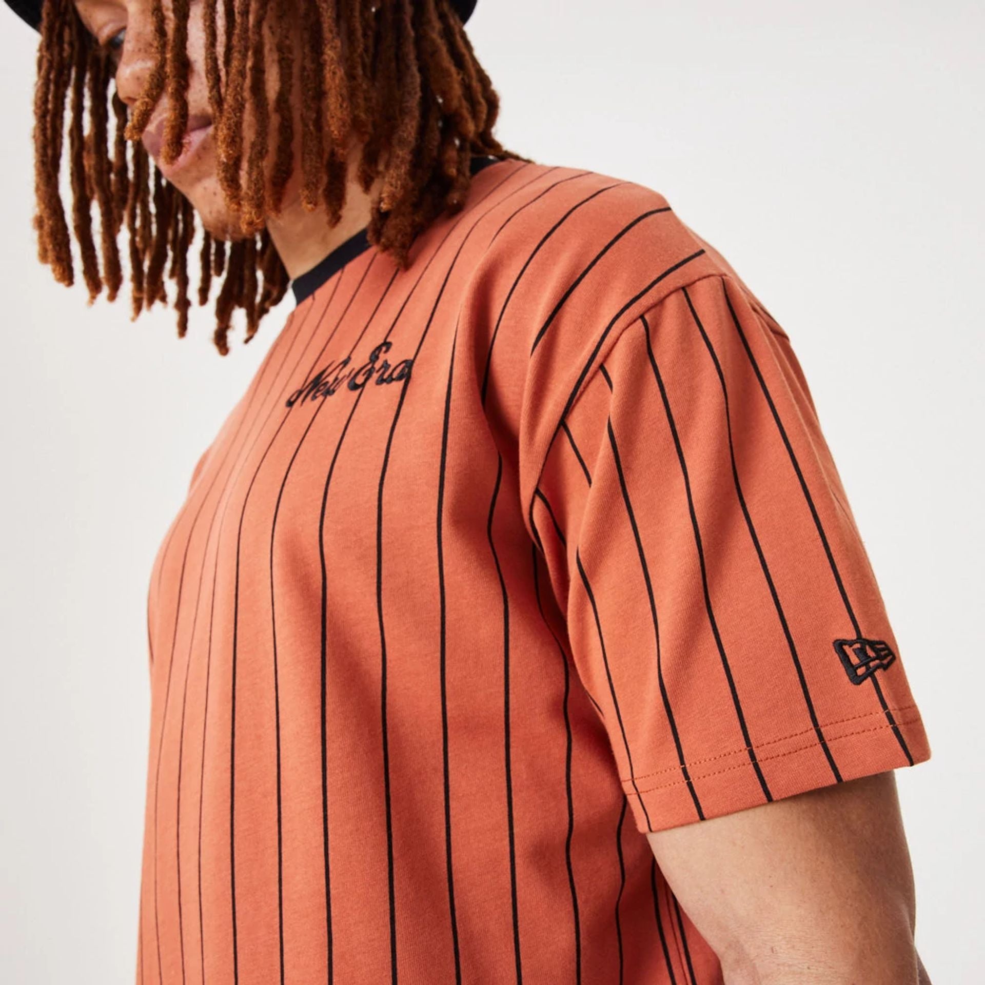 The Male model is wearing New Era Pinstripe Medium Brown Oversized T-Shirt 4