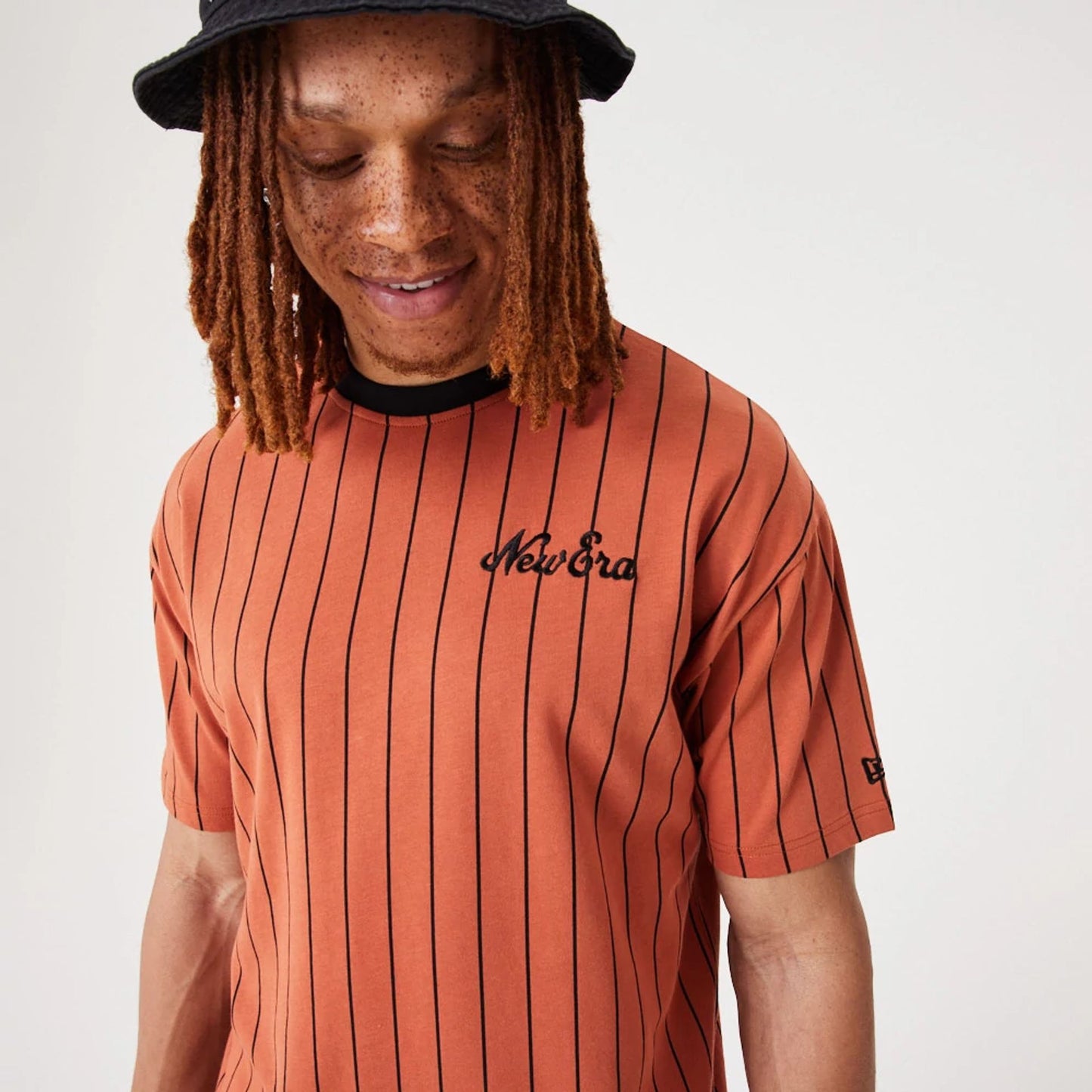 The Male model is wearing New Era Pinstripe Medium Brown Oversized T-Shirt 5