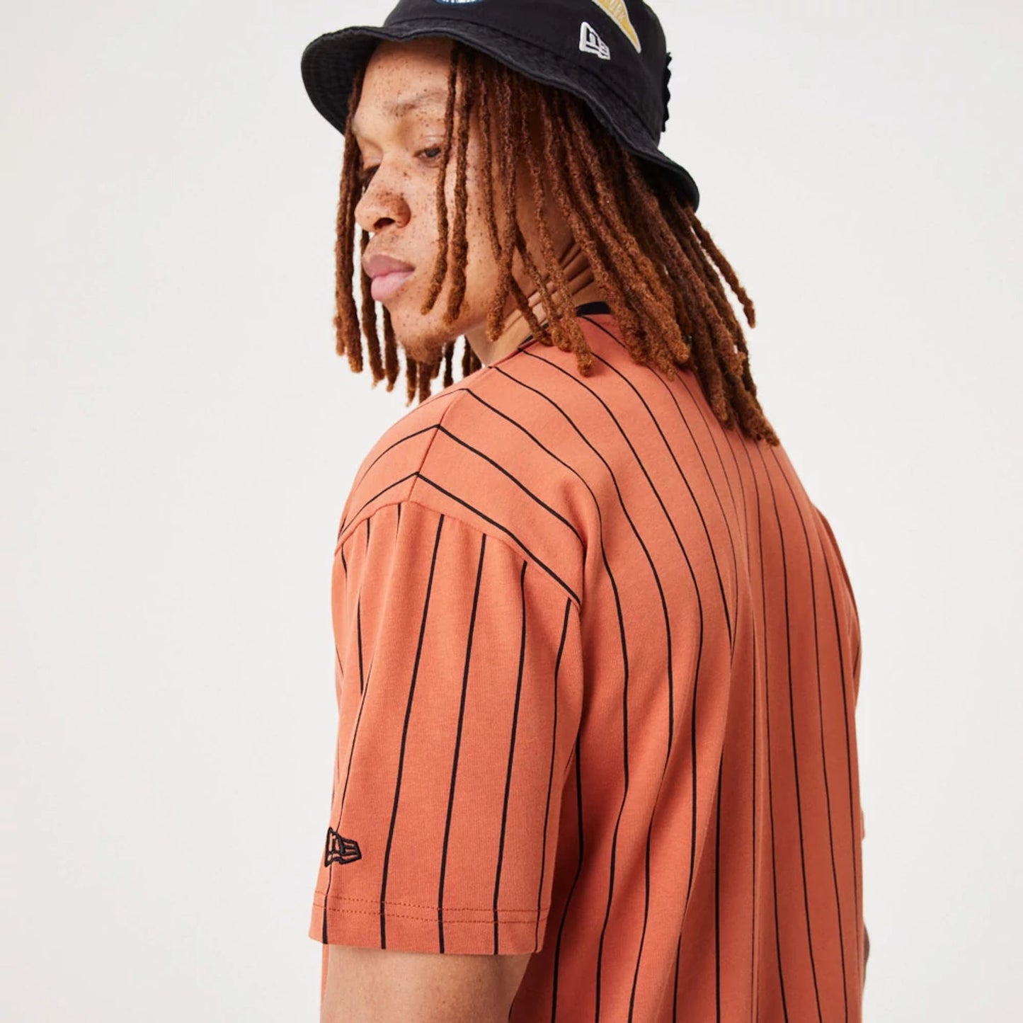 The Male model is wearing New Era Pinstripe Medium Brown Oversized T-Shirt 6