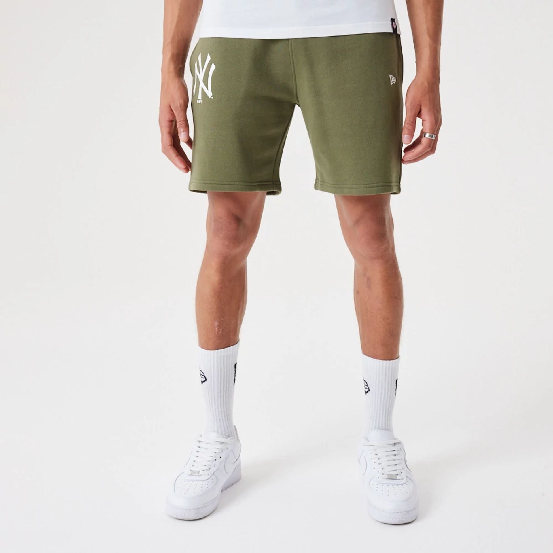 The Male model is wearing New York Yankees MLB League Essential Medium Green Shorts 1