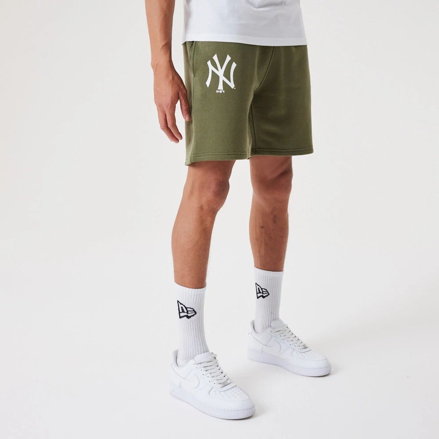 The Male model is wearing New York Yankees MLB League Essential Medium Green Shorts 6