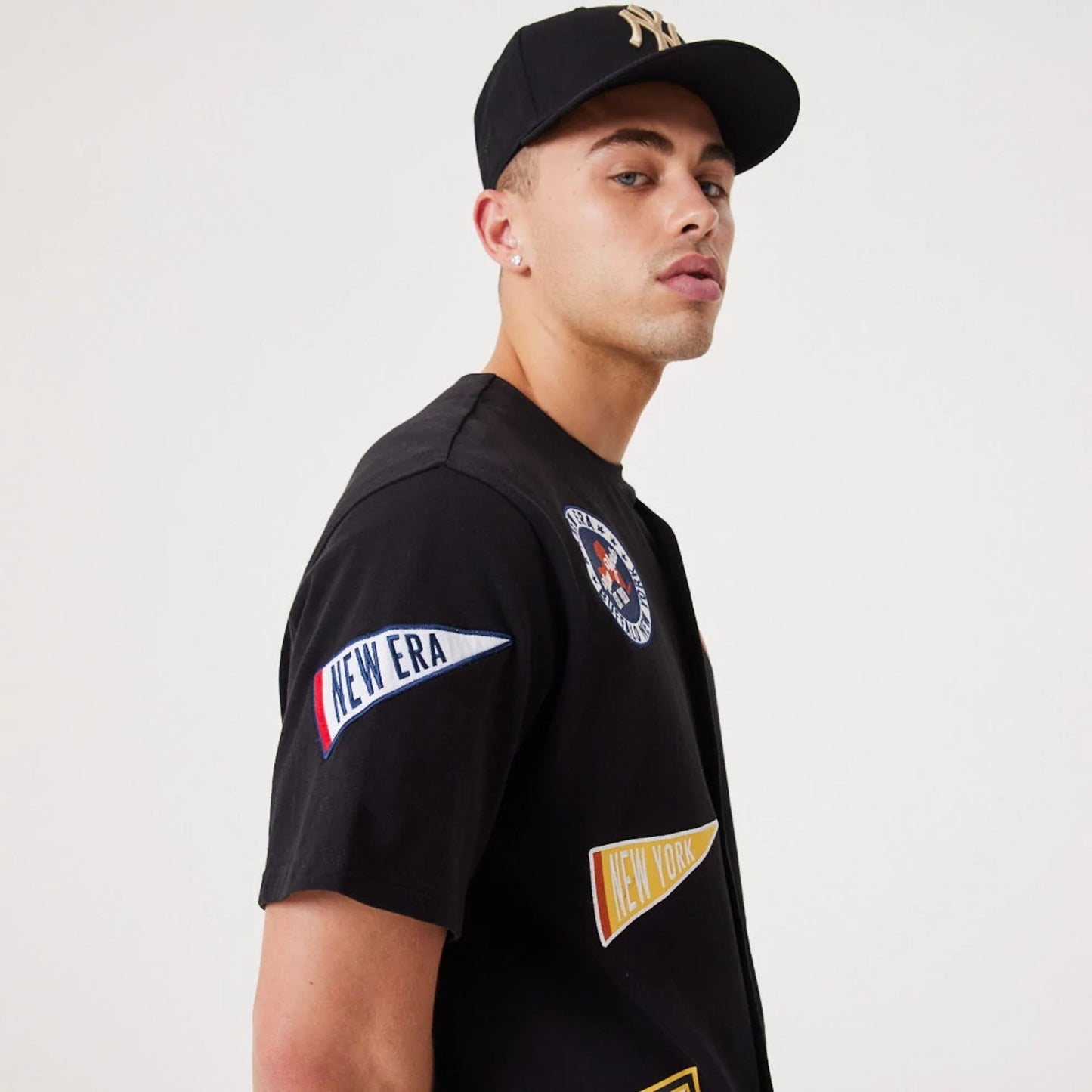 The Male model is wearing New Era Heritage Badge Black Jersey 6