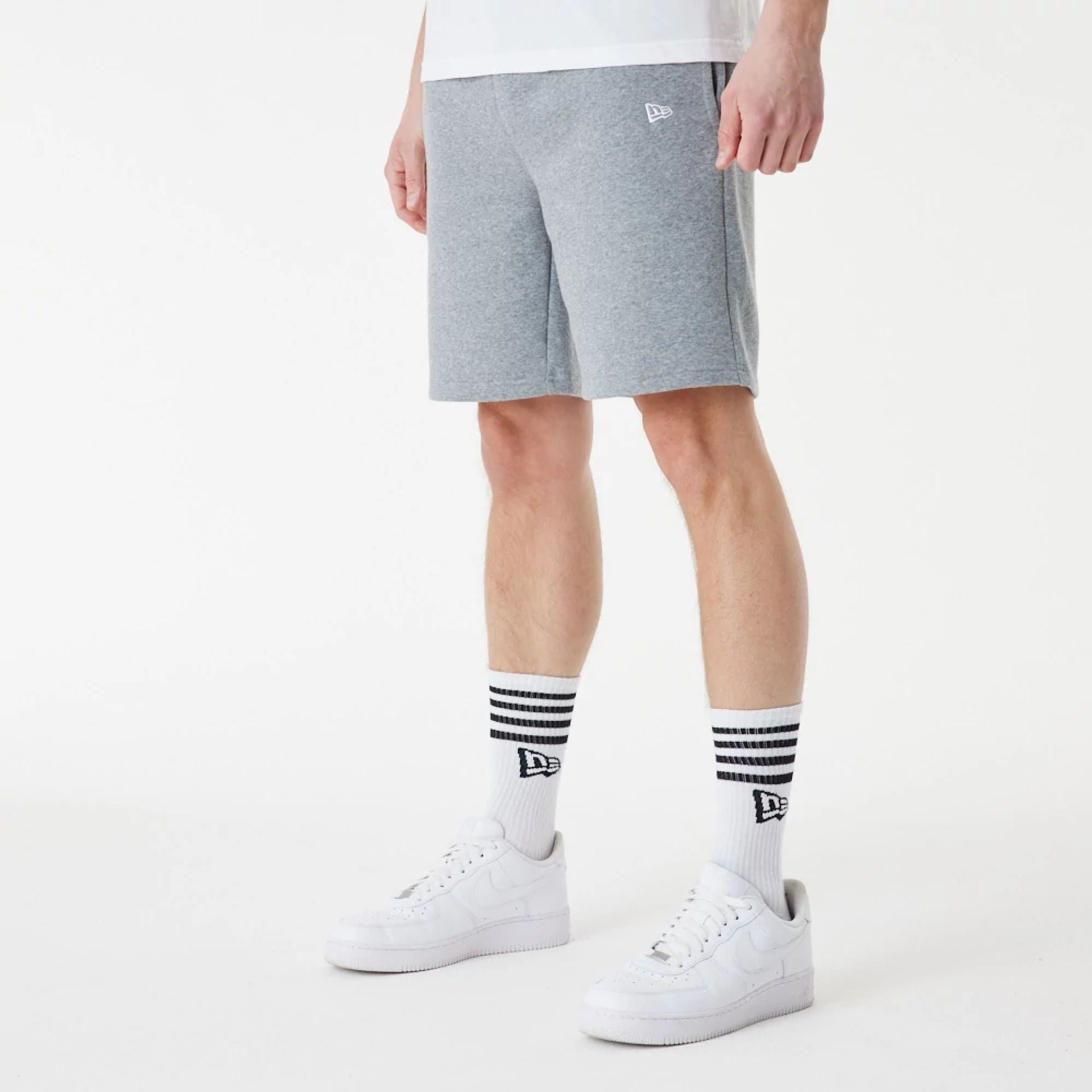 The Male model is wearing New Era Grey Essential Shorts 2