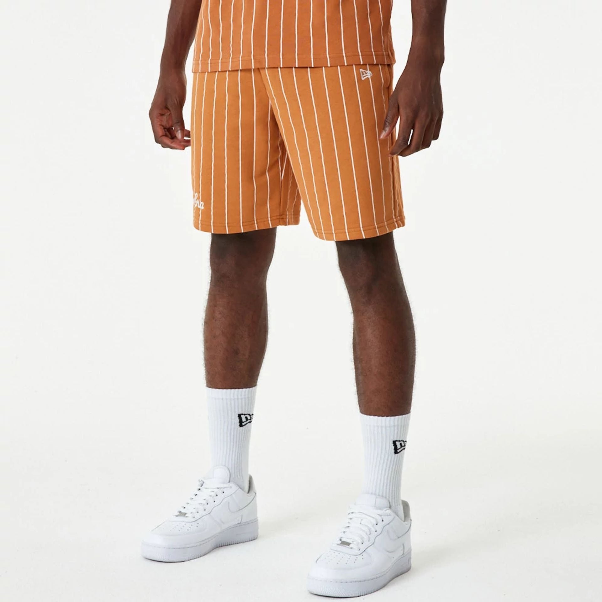 The Male model is wearing New Era Pinstripe Orange Shorts 5