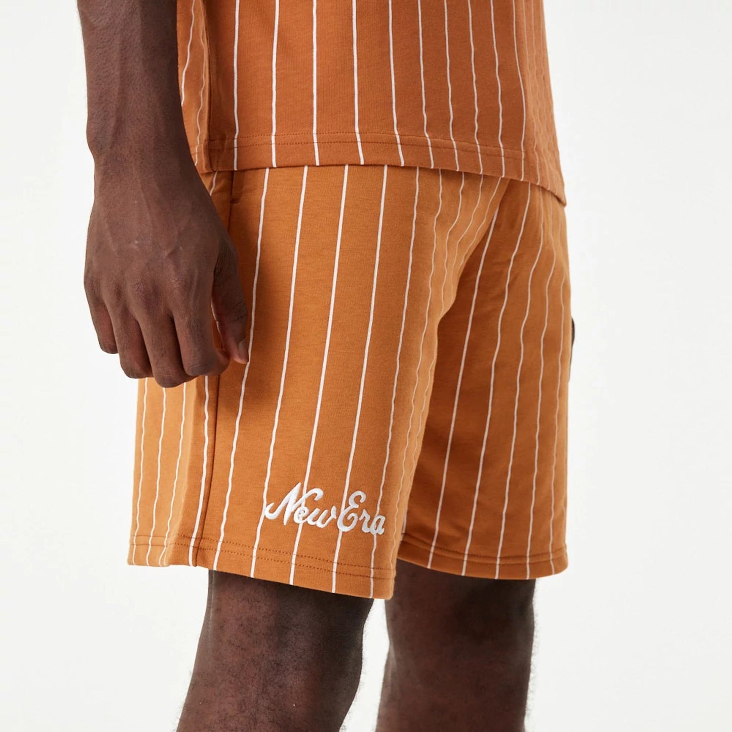 The Male model is wearing New Era Pinstripe Orange Shorts 8