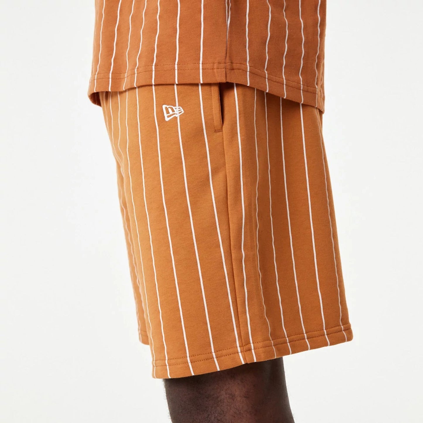 The Male model is wearing New Era Pinstripe Orange Shorts 6