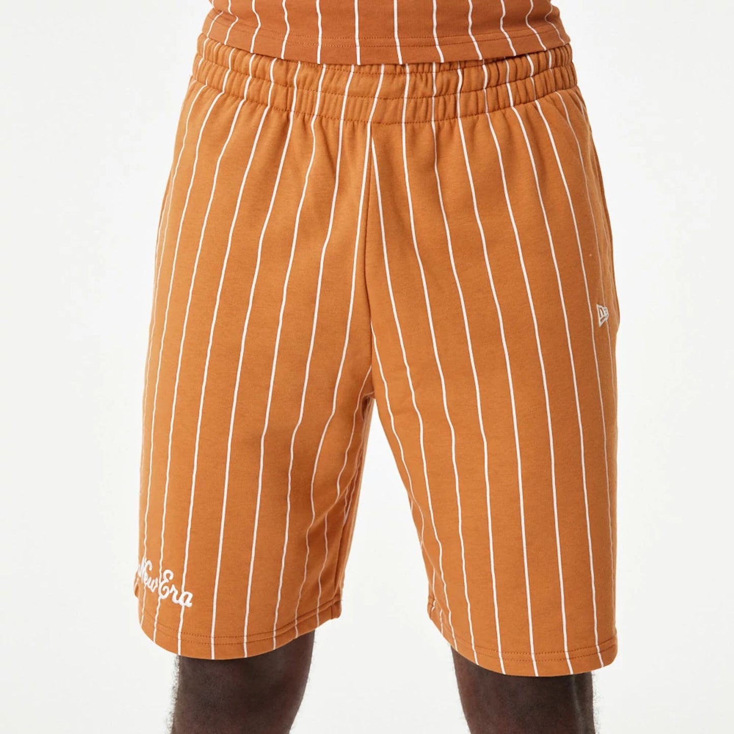 The Male model is wearing New Era Pinstripe Orange Shorts 3