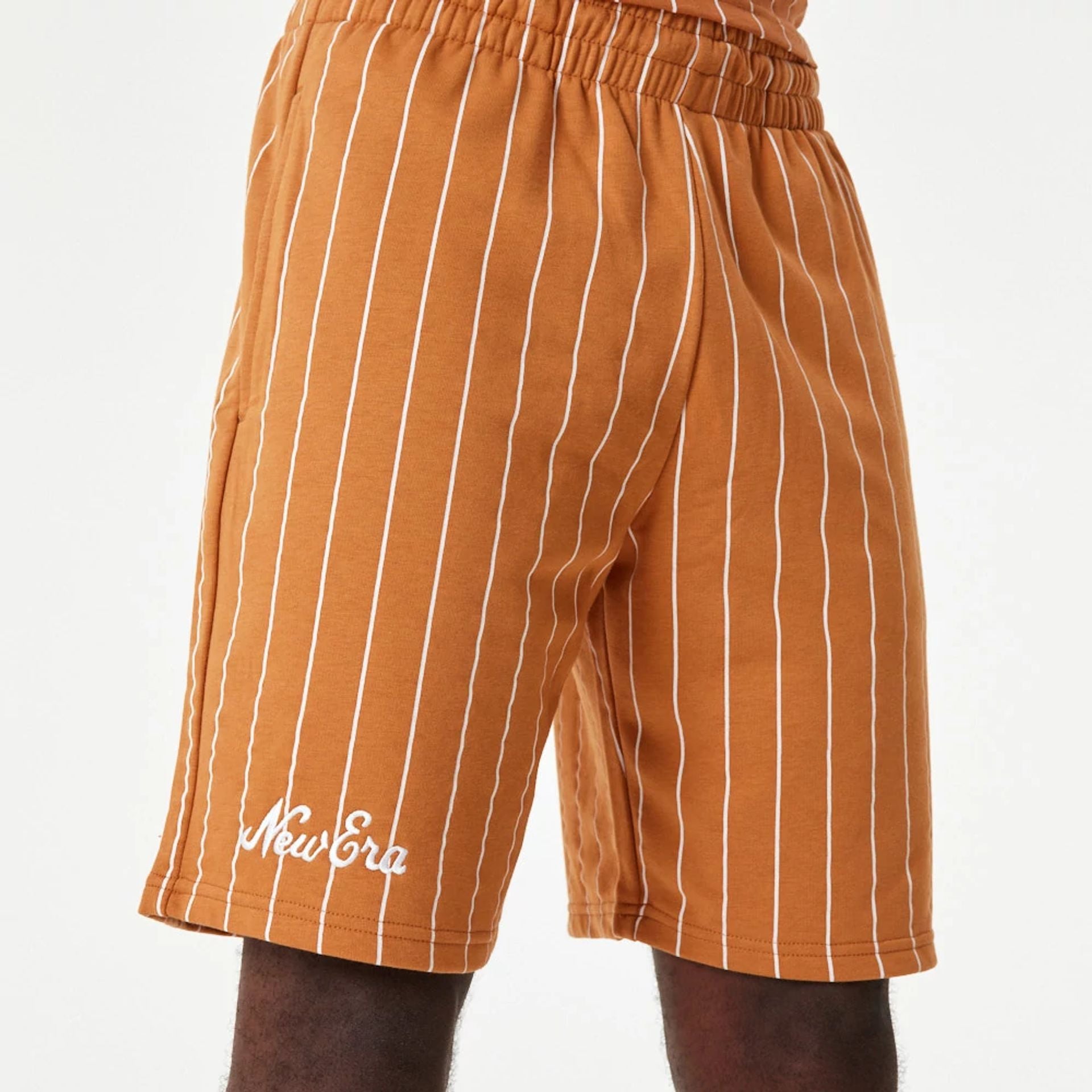 The Male model is wearing New Era Pinstripe Orange Shorts 1