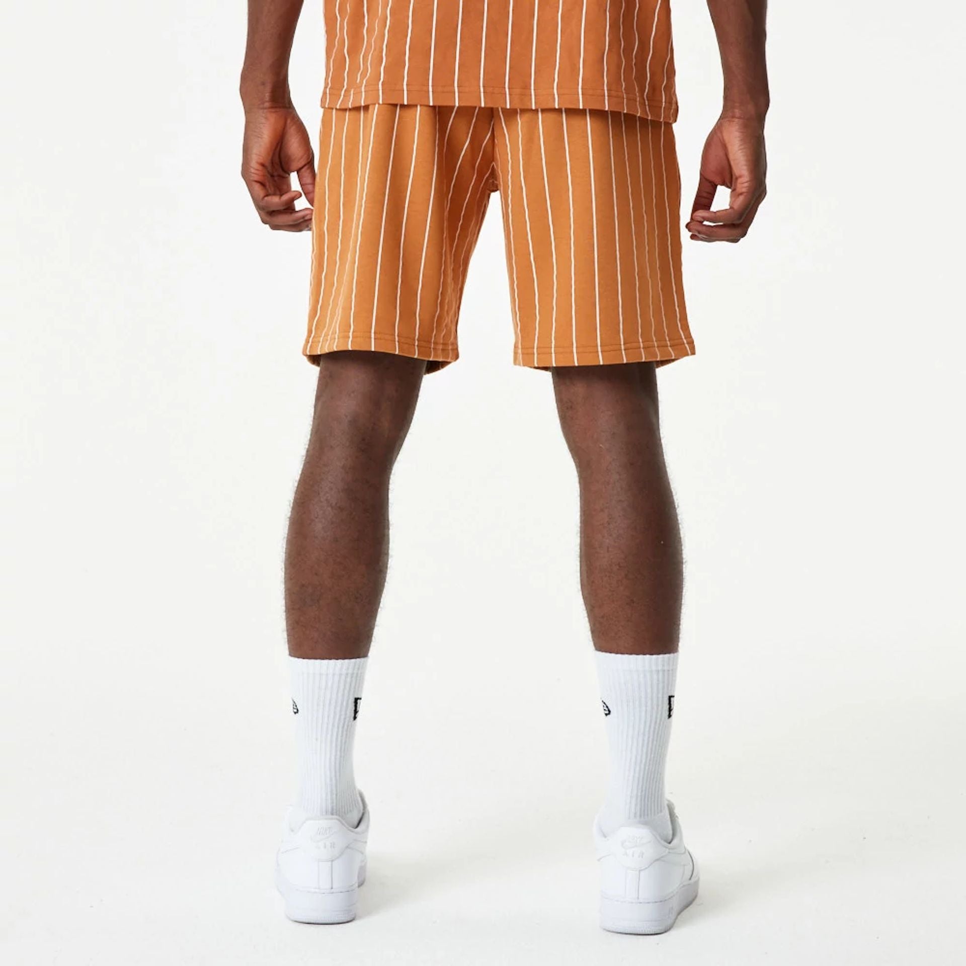 The Male model is wearing New Era Pinstripe Orange Shorts 4