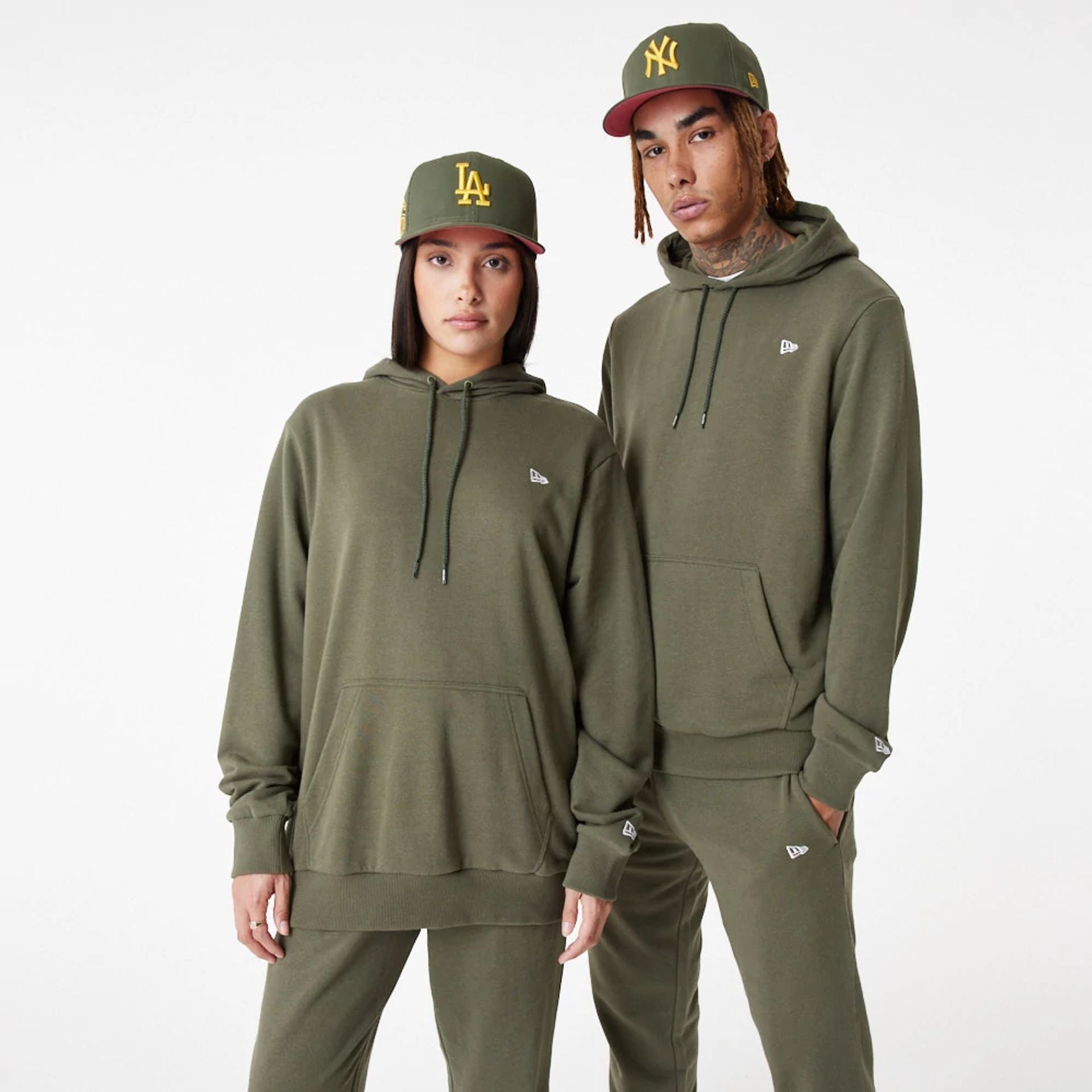 The Male model is wearing New Era Essential Green Pullover Hoodie 2