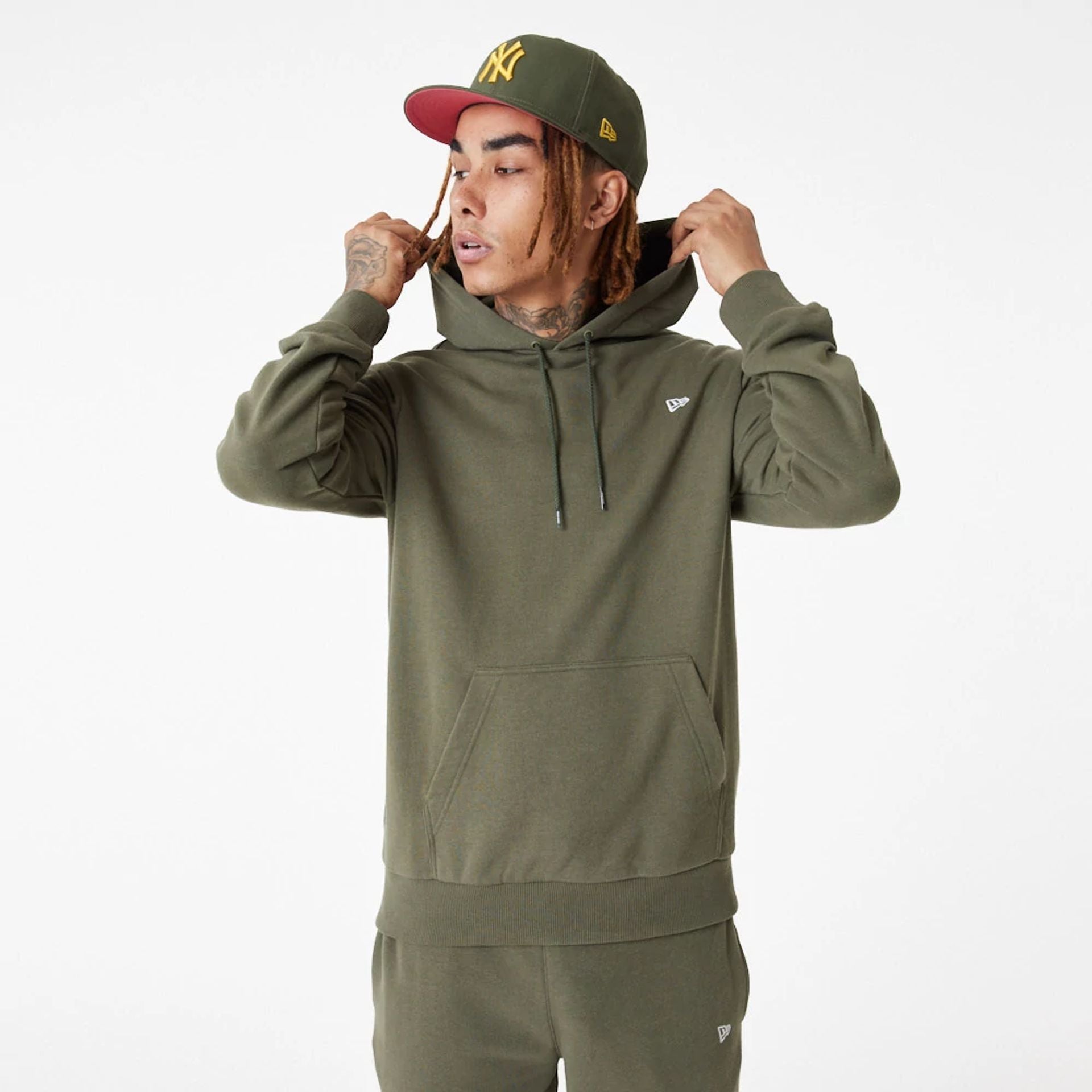 The Male model is wearing New Era Essential Green Pullover Hoodie 7