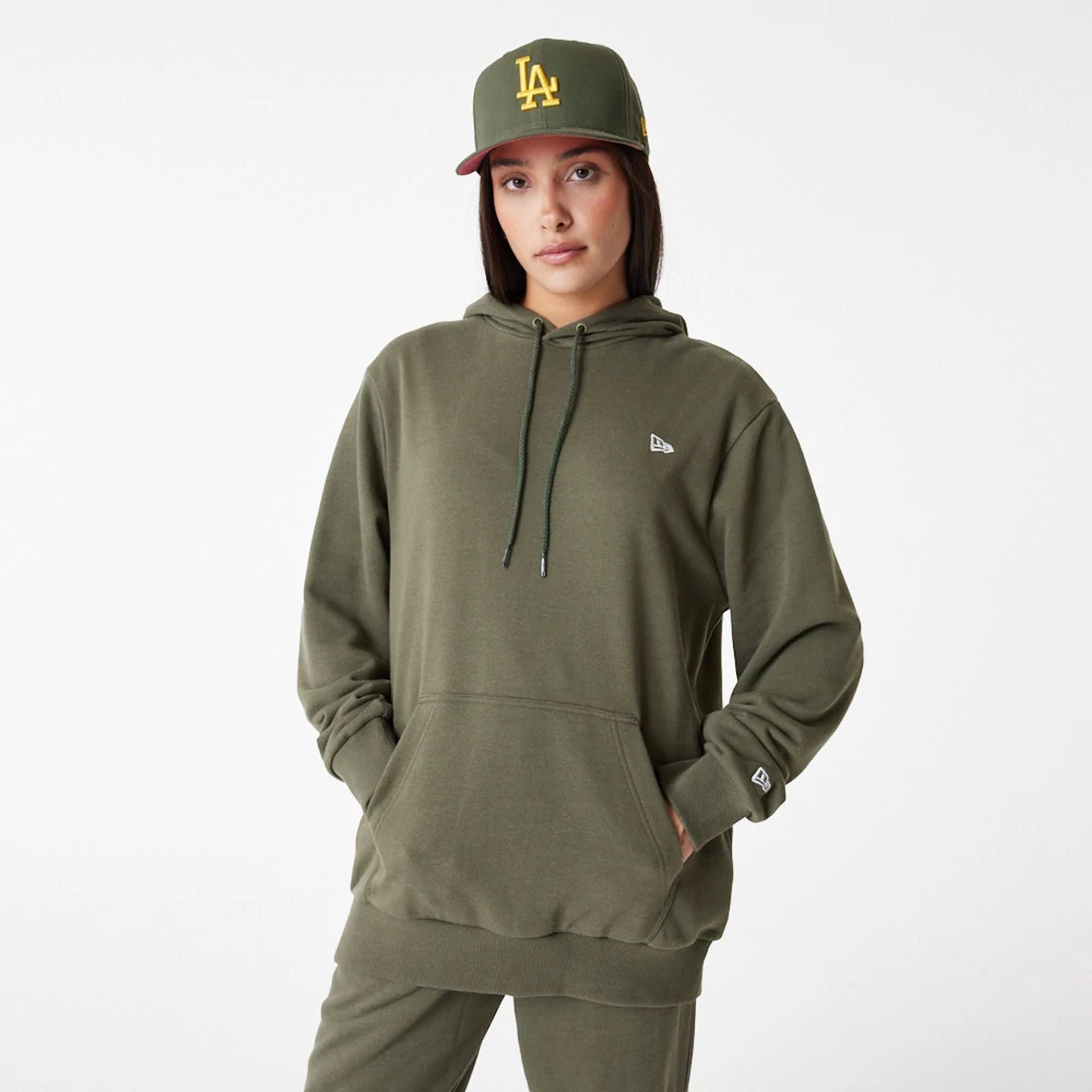 The Male model is wearing New Era Essential Green Pullover Hoodie 8