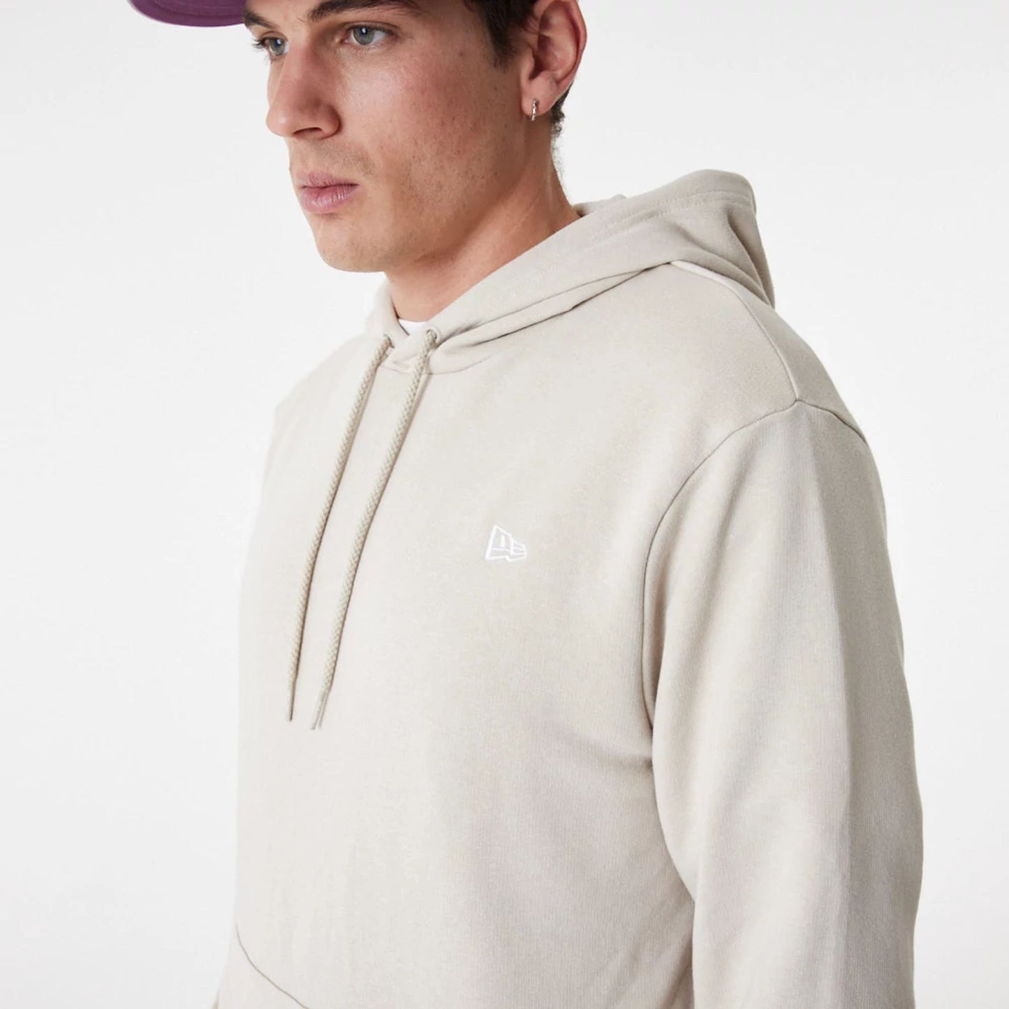 The Male model is wearing New Era Essential Stone Pullover Hoodie 6