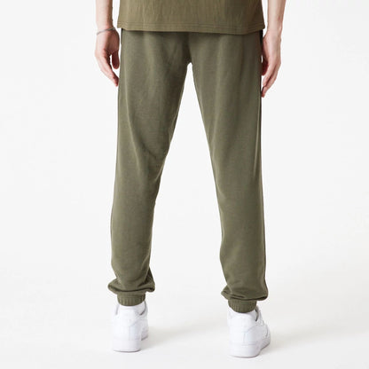 The Male model is wearing New Era Essential Green Joggers 4