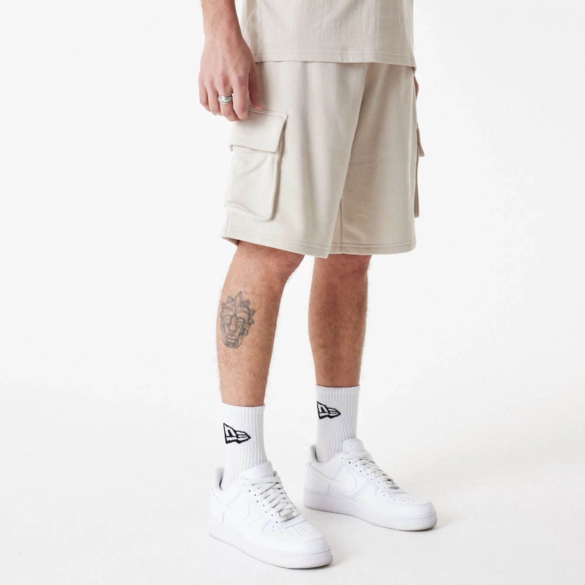 The Male model is wearing New Era Essential Stone Shorts 2