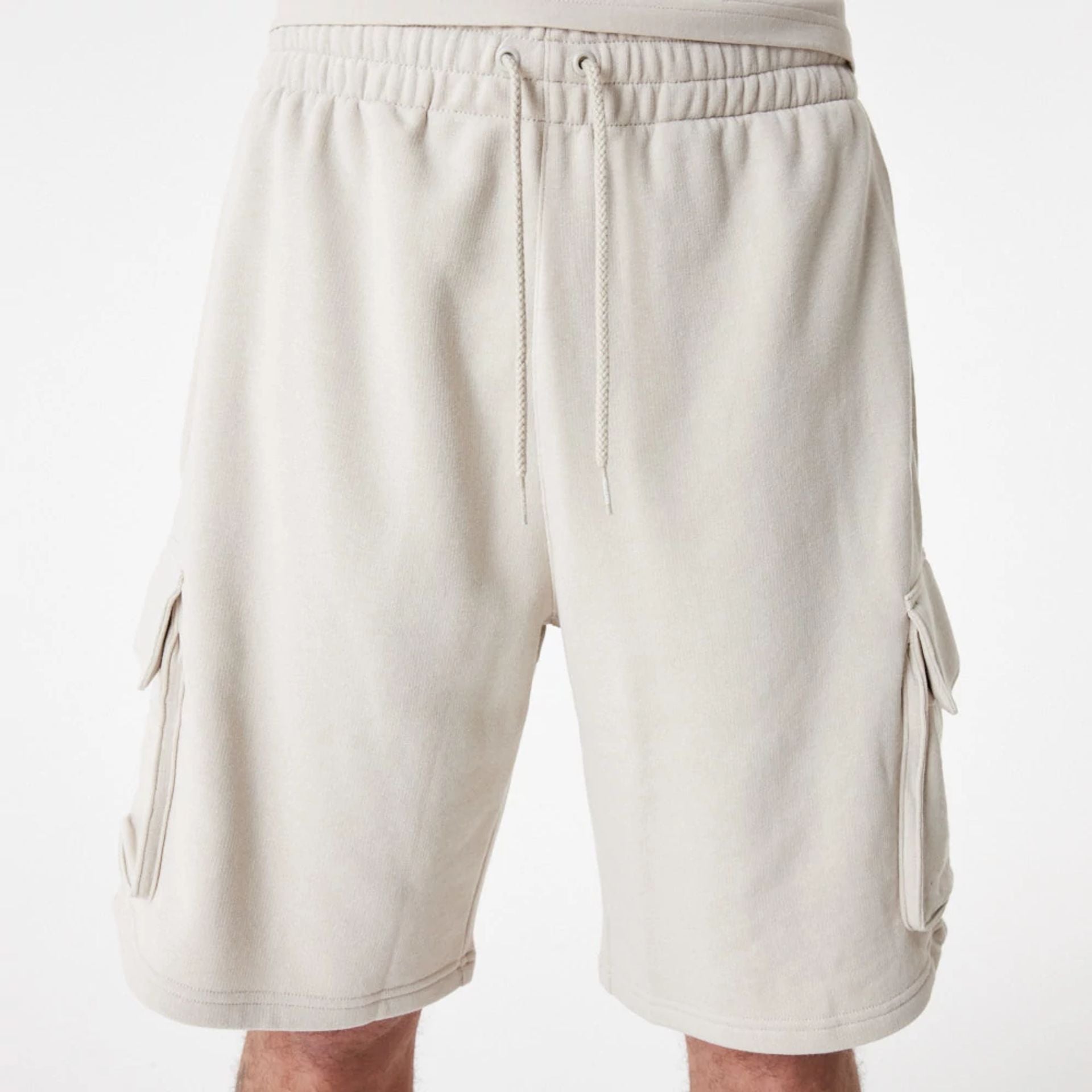 The Male model is wearing New Era Essential Stone Shorts 4