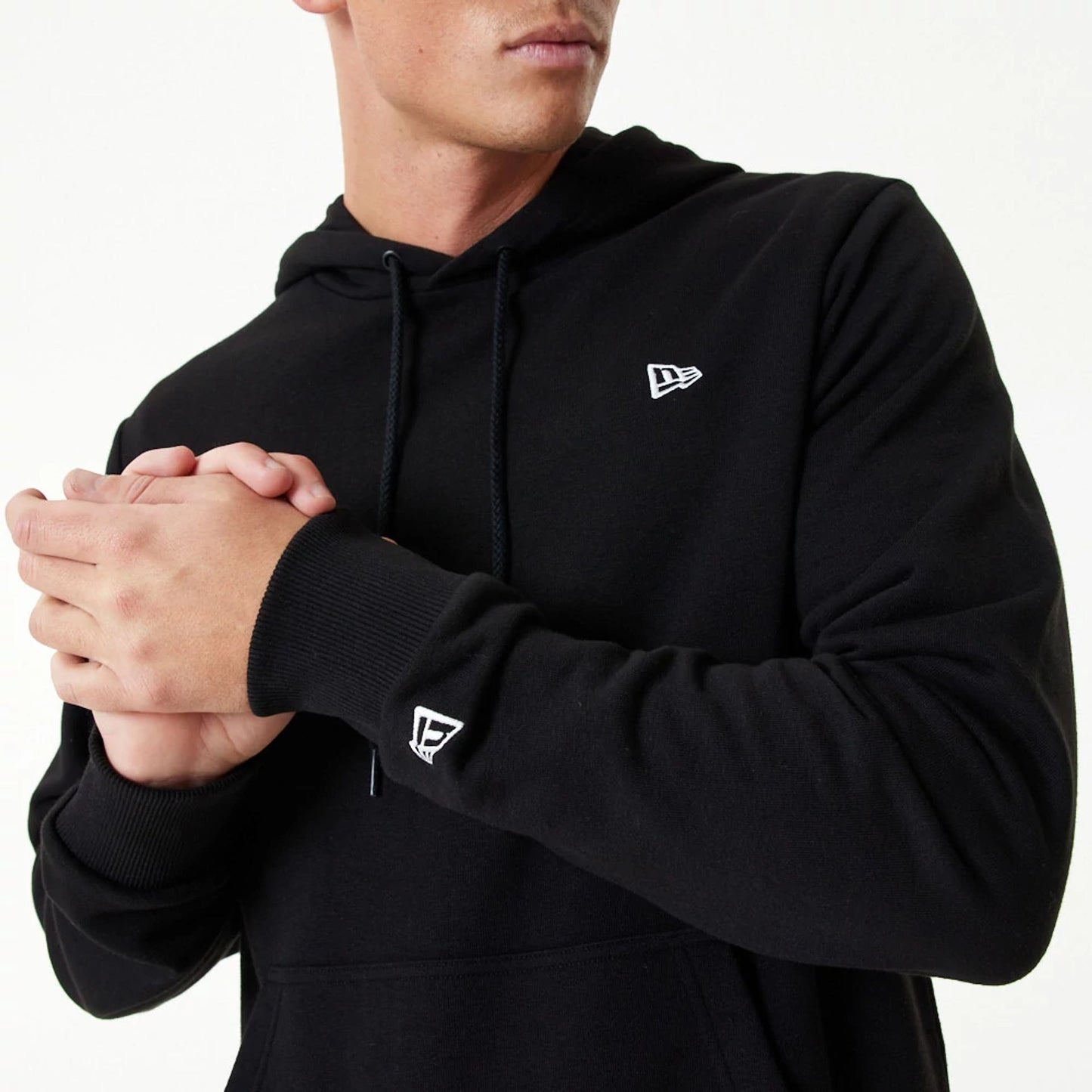 The Male model is wearing New Era Essential Black Pullover Hoodie 2