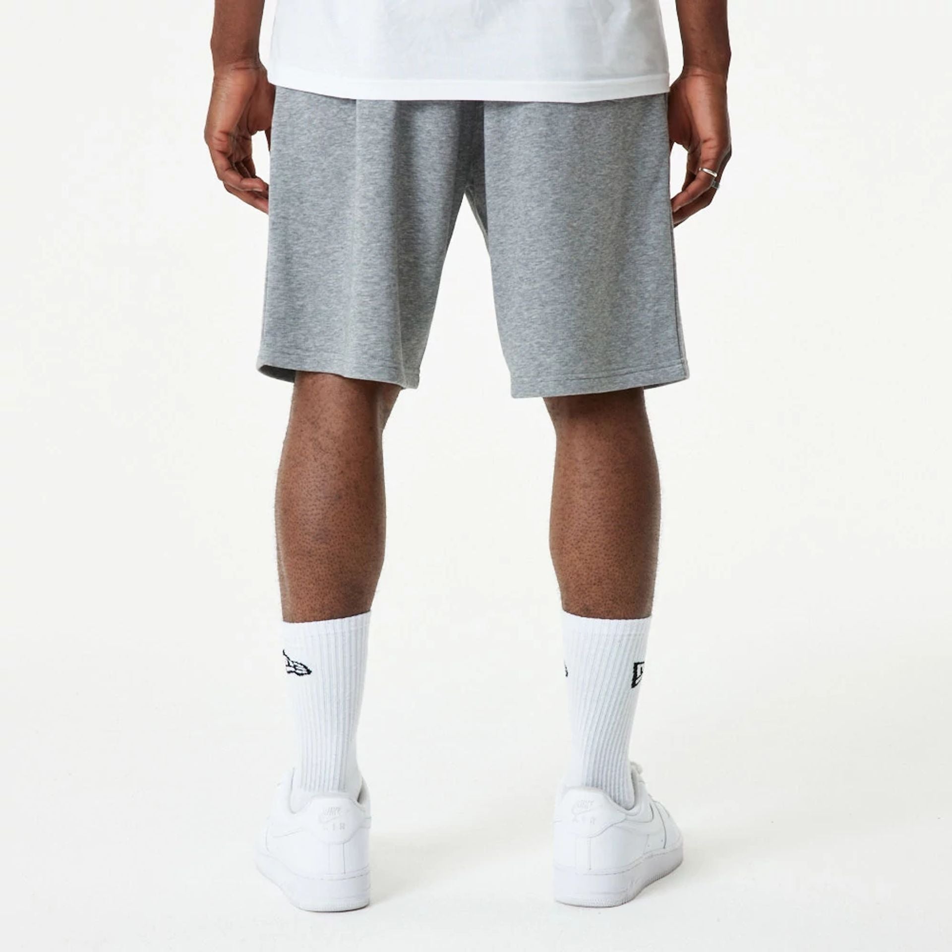 The Male model is wearing New Era Essential Grey Shorts 7